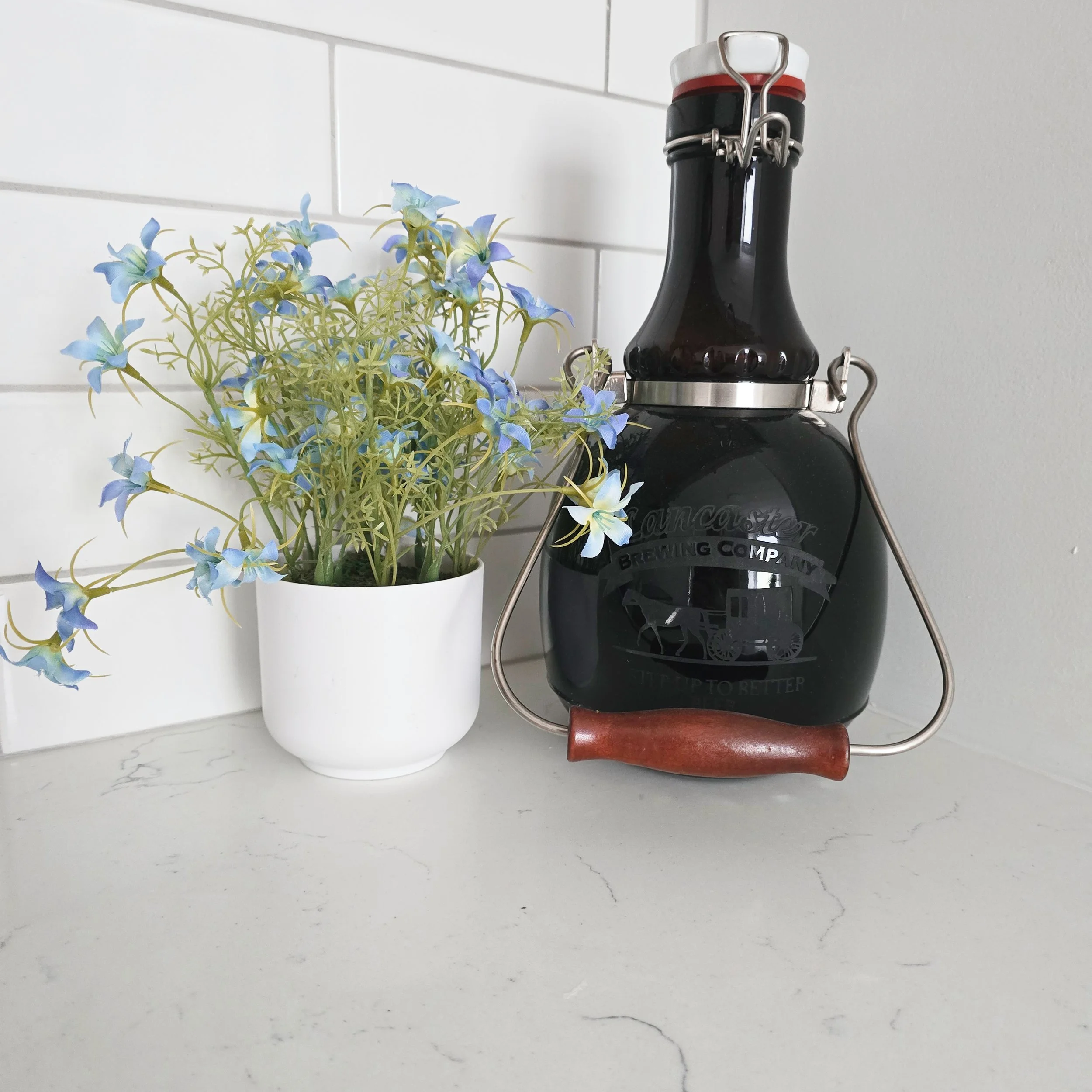 Kitchen counter styling in a Lancaster, PA home featuring decorative accessories, greenery, and carefully selected accents as part of a professional home staging project.