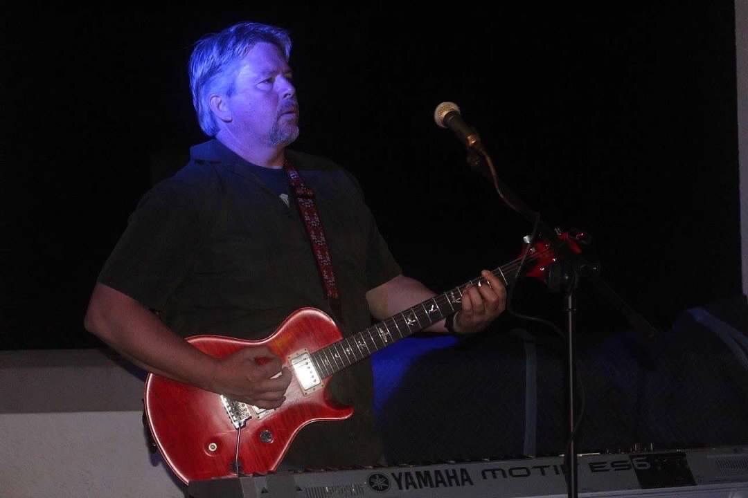 Anthony w guitar black background.jpeg