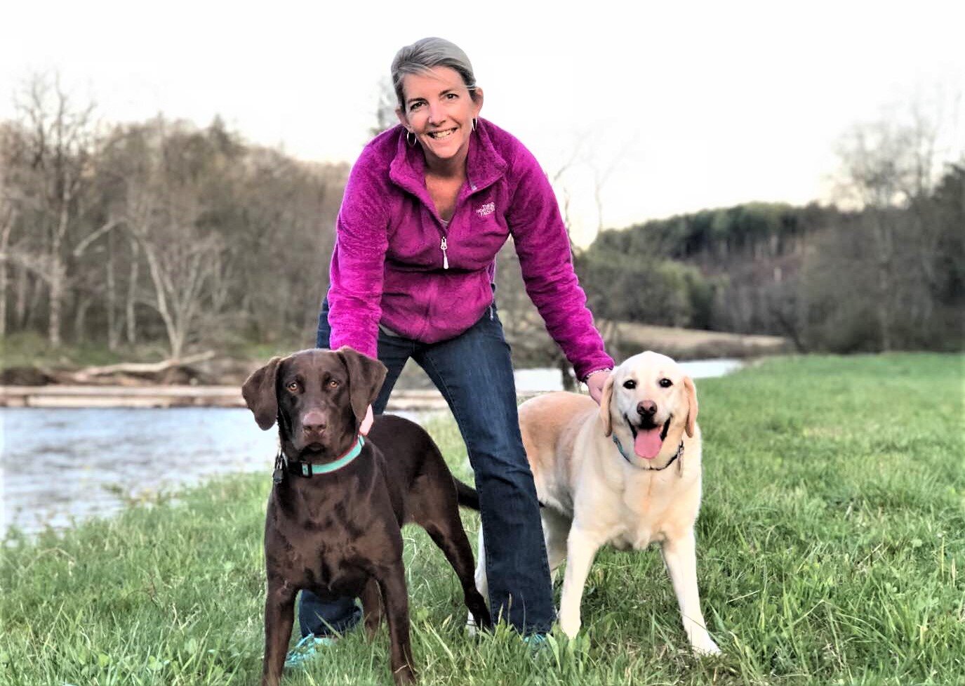 Daughter Allison Harper Farmer with her dogs Kona and Lulu at Allison and John Farmer's river house in West Jefferson, NC