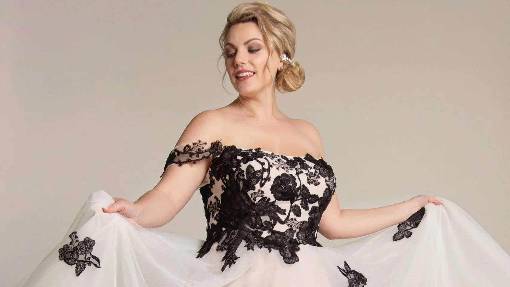 Bride descending staircase in Graceful wedding dress