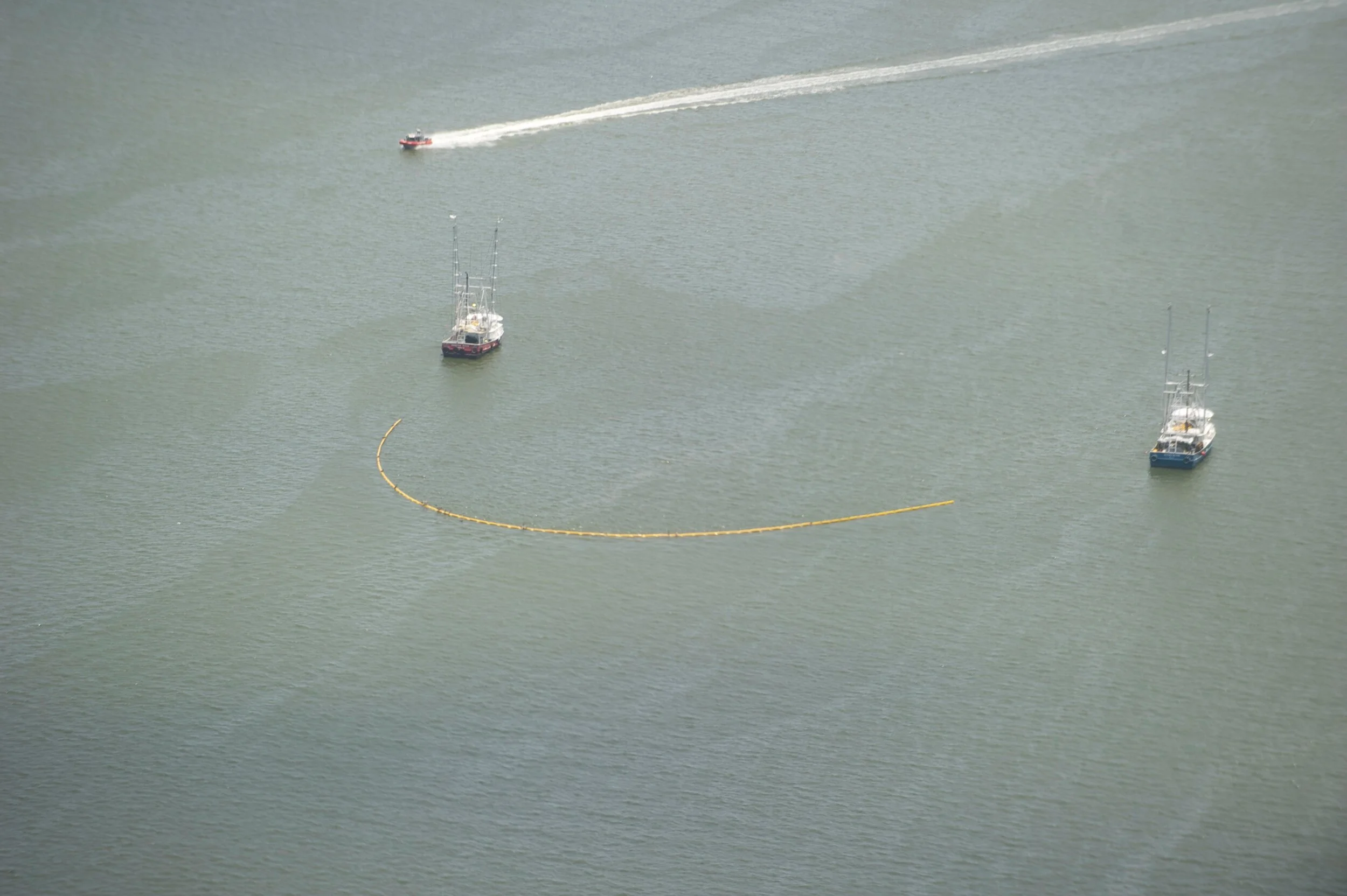 Shrimp boats dragging oil booms in Barataria Bay just North of Grand Isle, LA