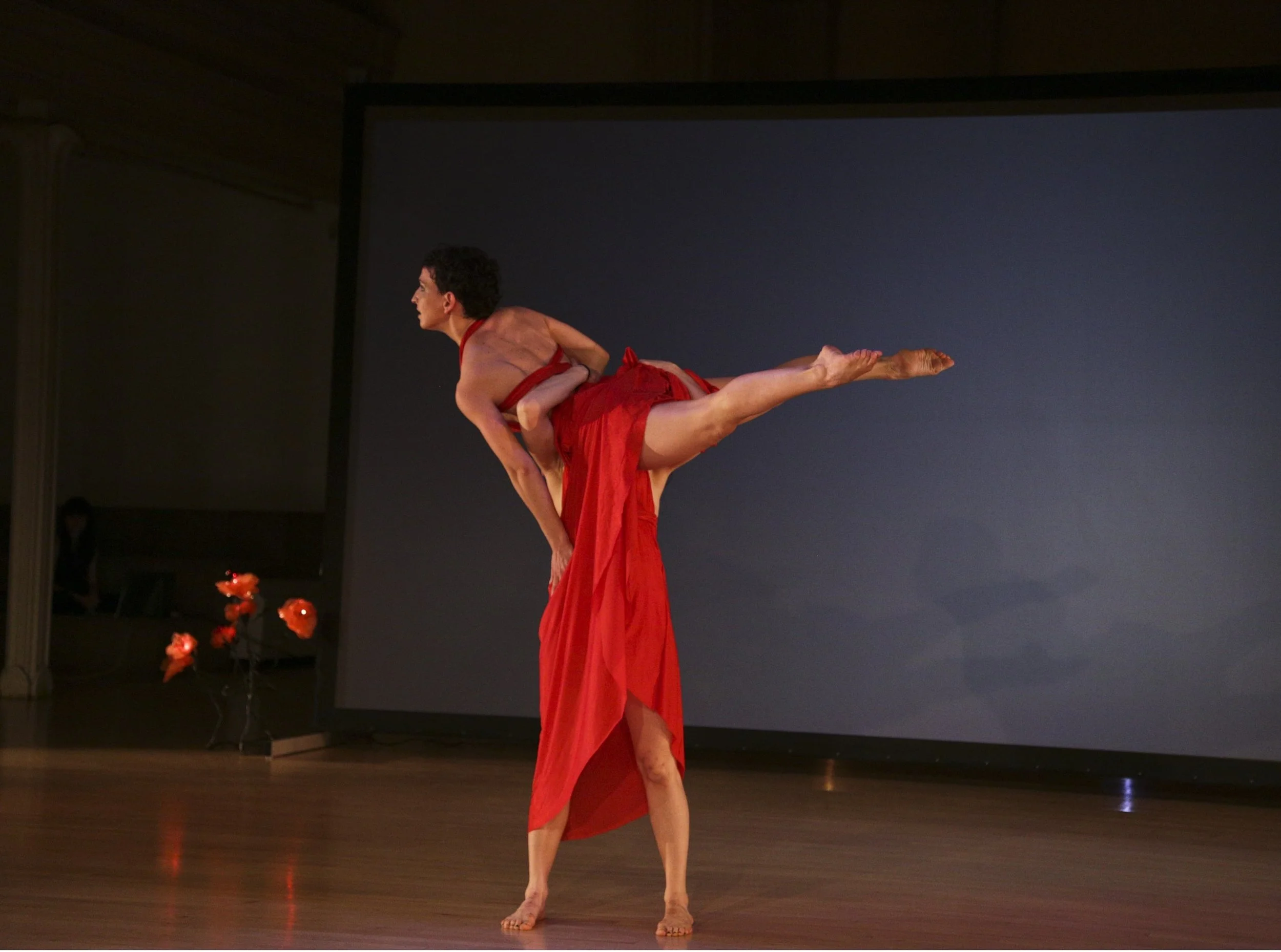 Valentina Priolo lifted in a duet during a muti media performance.