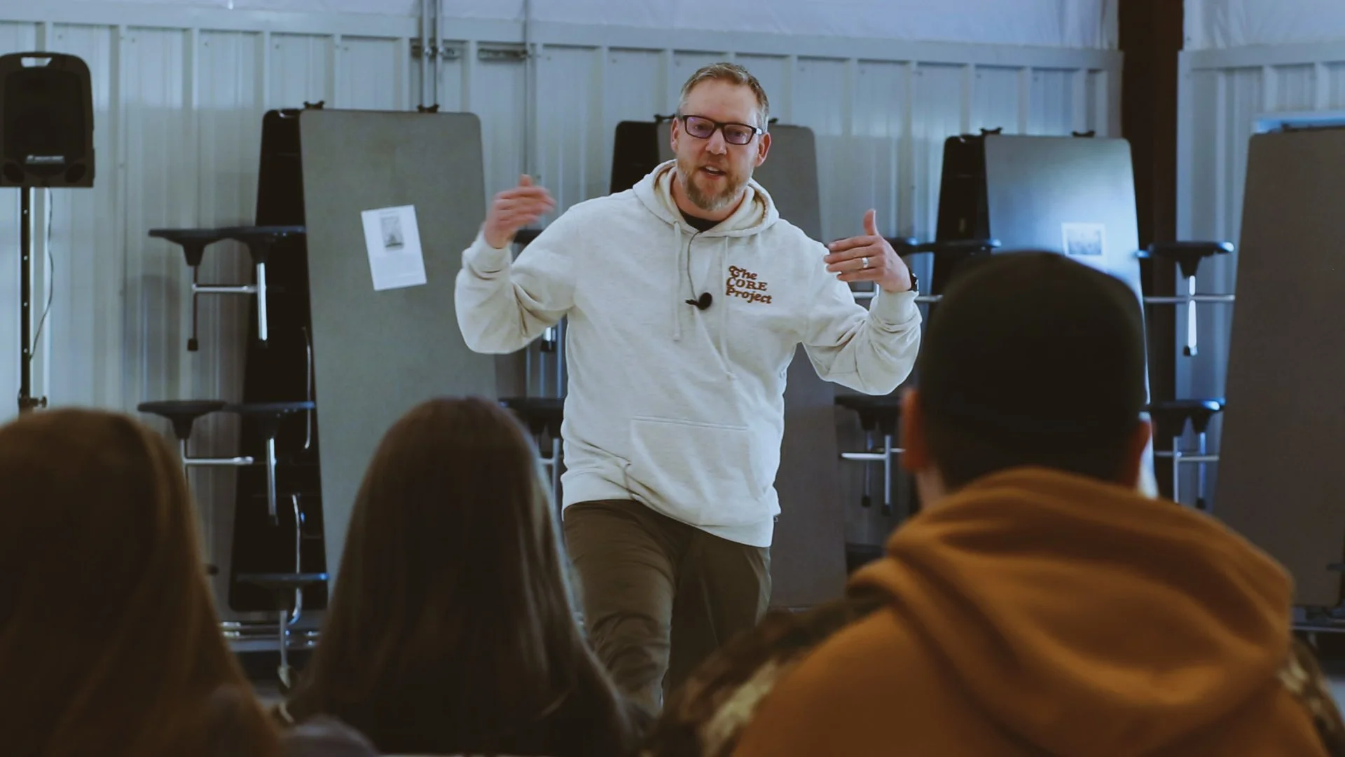 Greg Sommers presenting during a Core Day assembly with students engaging.