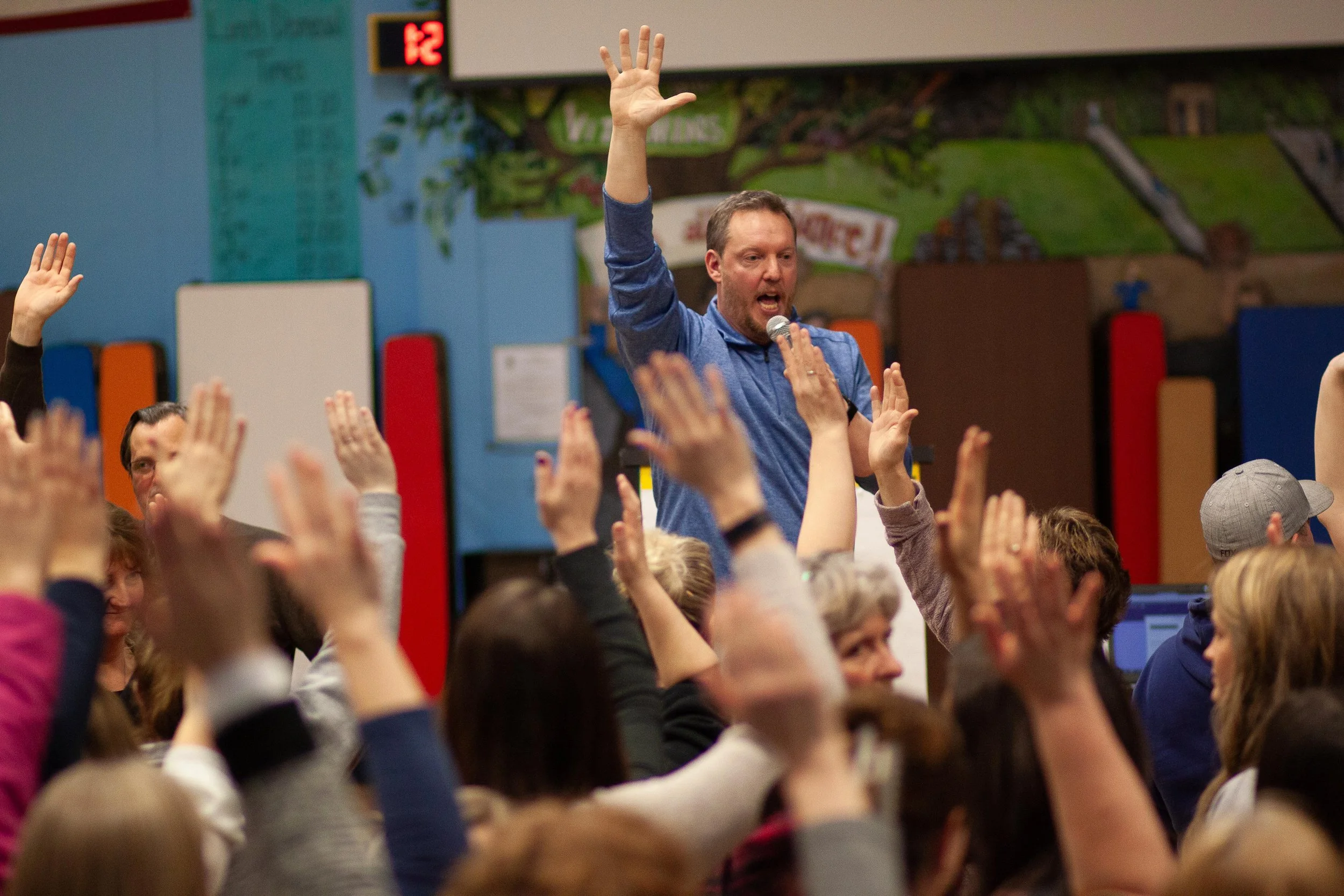Greg Sommers leading a large-group experience at a school.