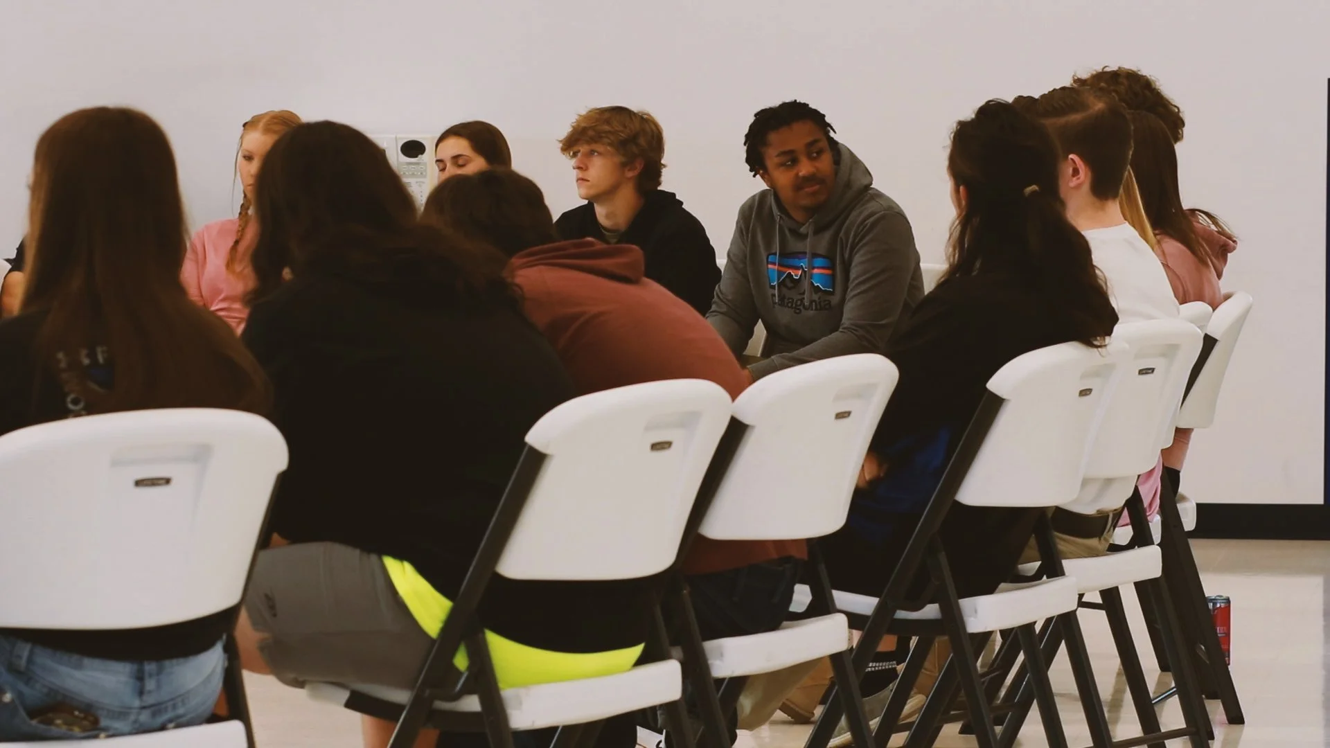 Students talking together in a small group during Core Day.