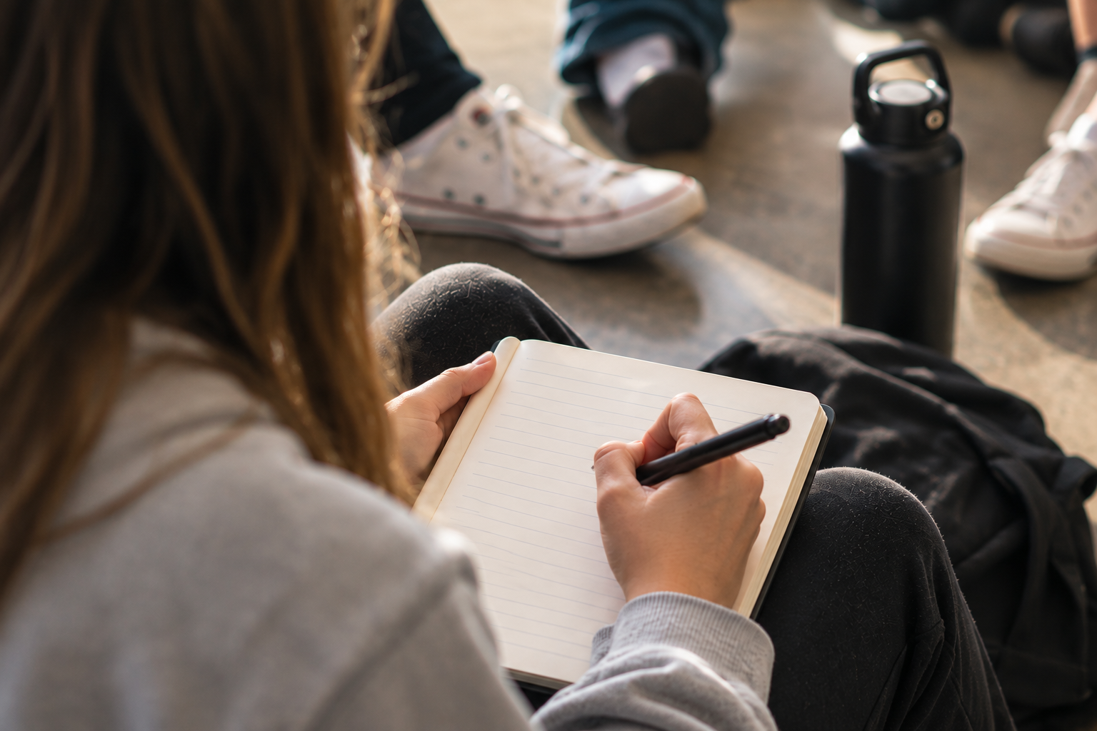 Student writing during a leadership training experience