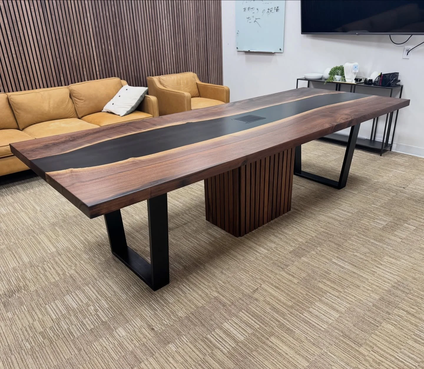 New conference table.
Live edge Walnut slabs paired with black resin.
96x43&rdquo;x30 Dimensions.
Featuring a pop up power box in the center. We also made a hollow box with slats to match the walls, also to hide all the cables that come from the floo
