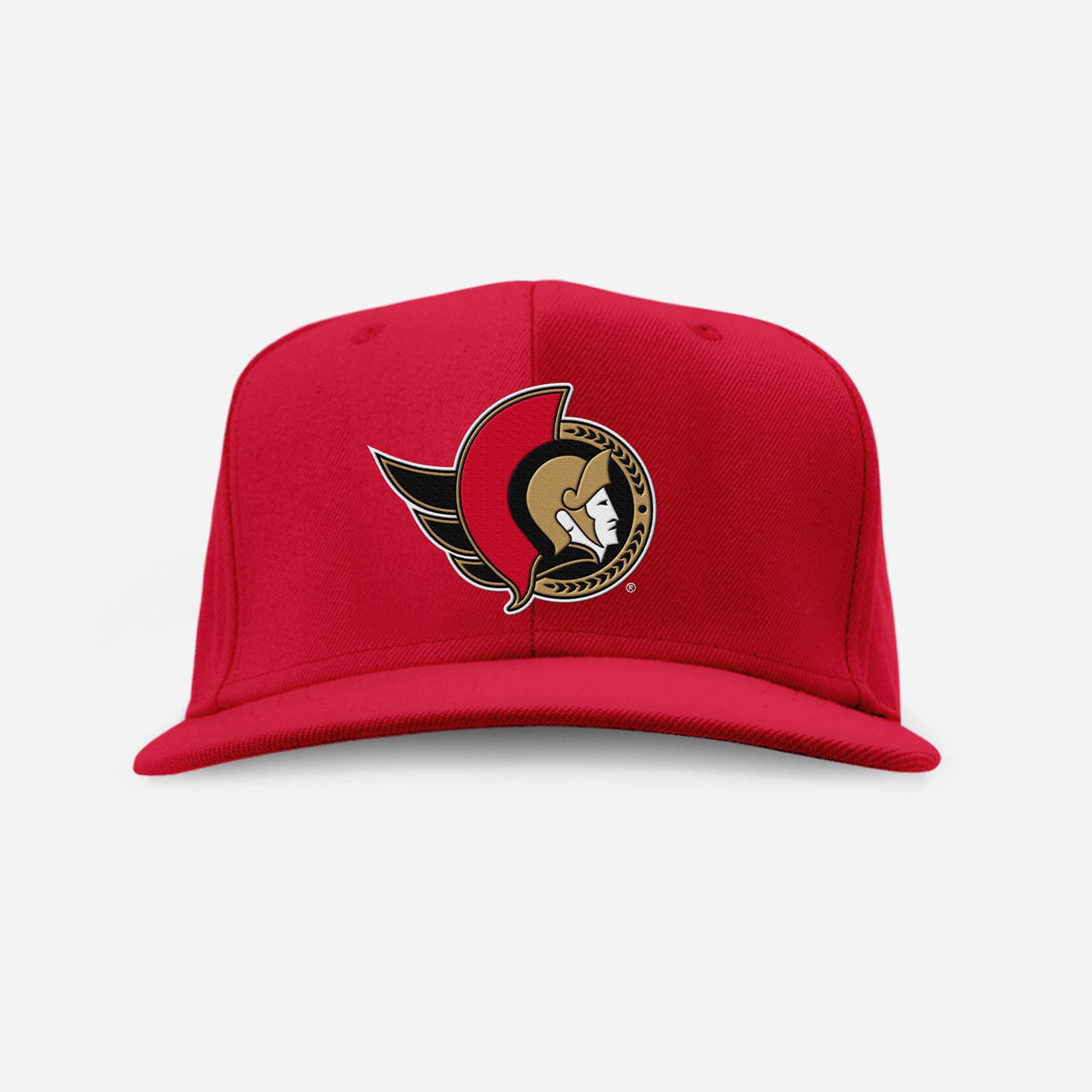 Red baseball cap with a logo featuring a stylized profile of a person, a helmet, and a tomahawk, against a light gray background.