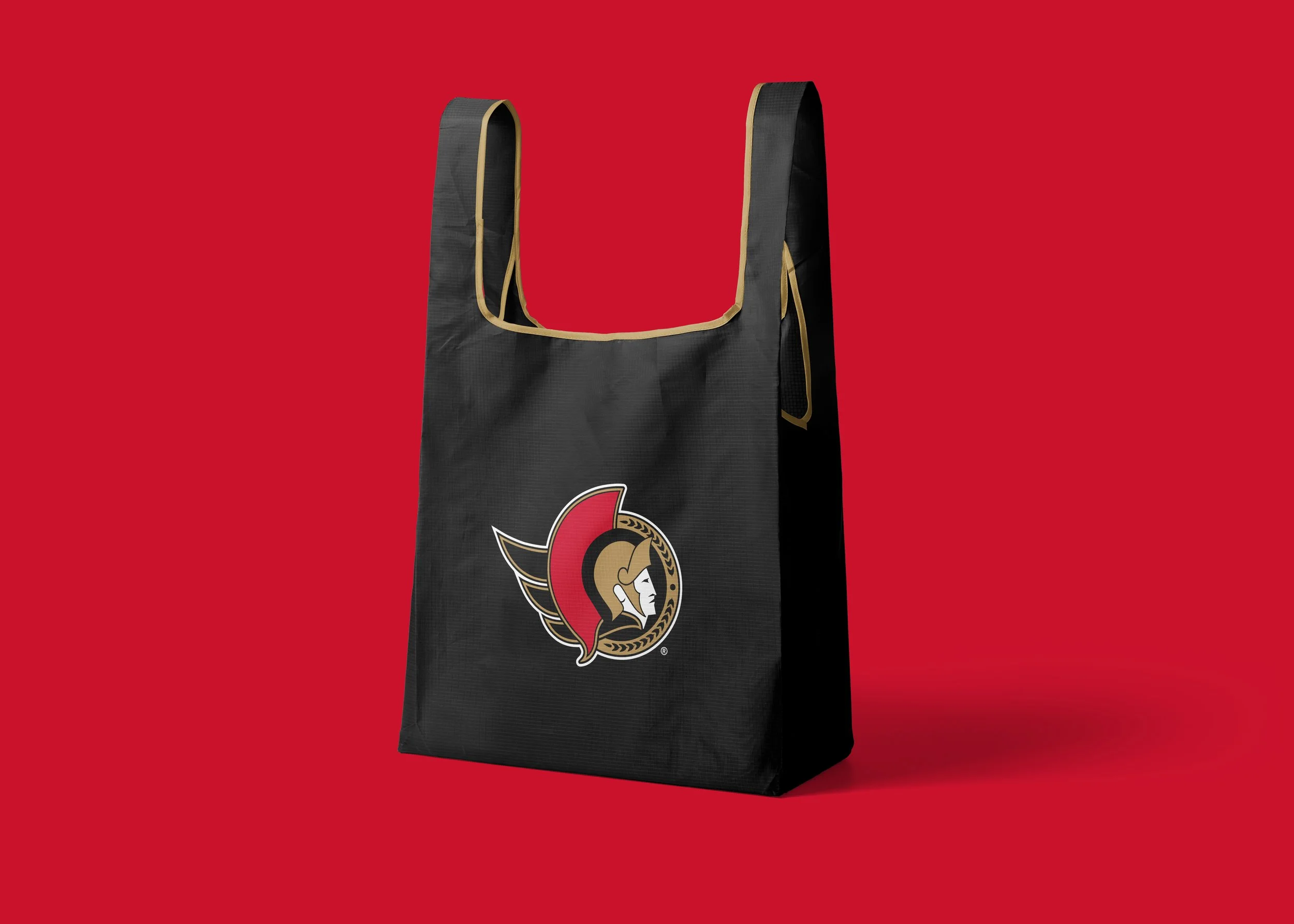 Black tote bag with gold trim and Ottawa Senators logo on a red background.