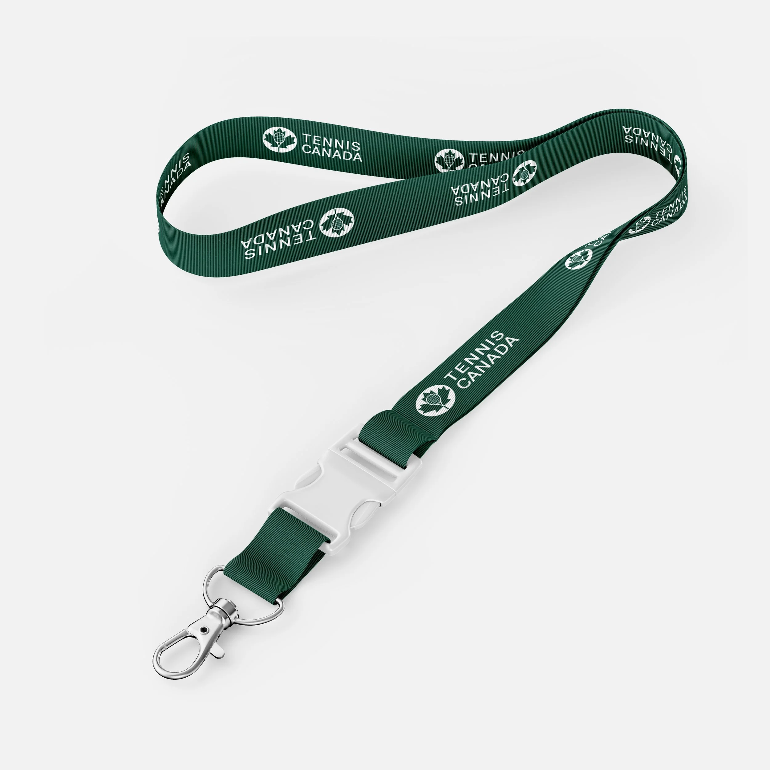 A tennis racket with a green lanyard that reads 'Tennis Canada' and features a maple leaf logo, laid out on a white background.