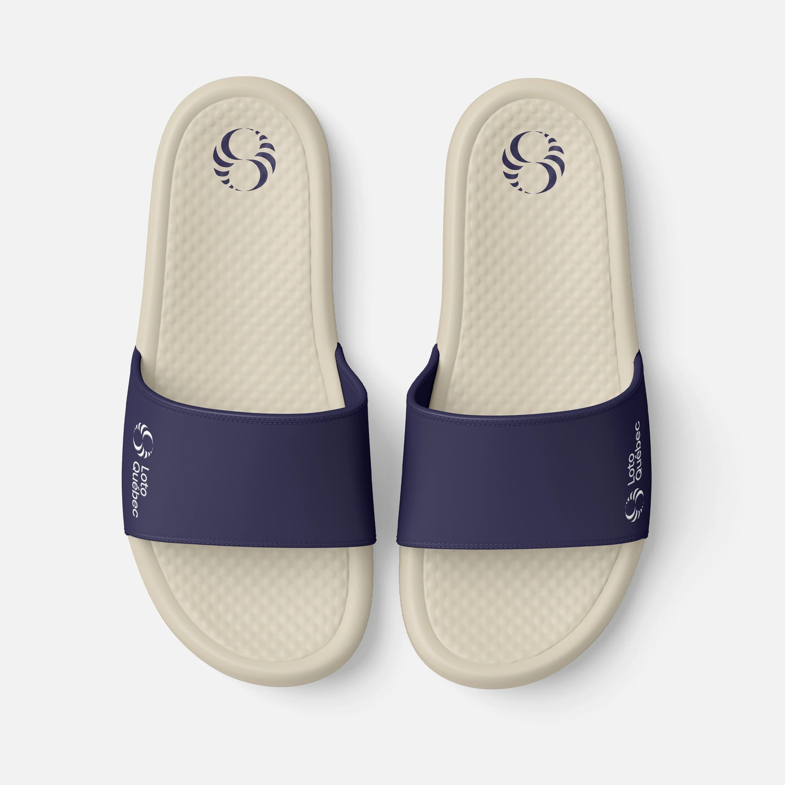 A pair of beige insoles with dark blue accents and a circular logo, positioned vertically on a white background.