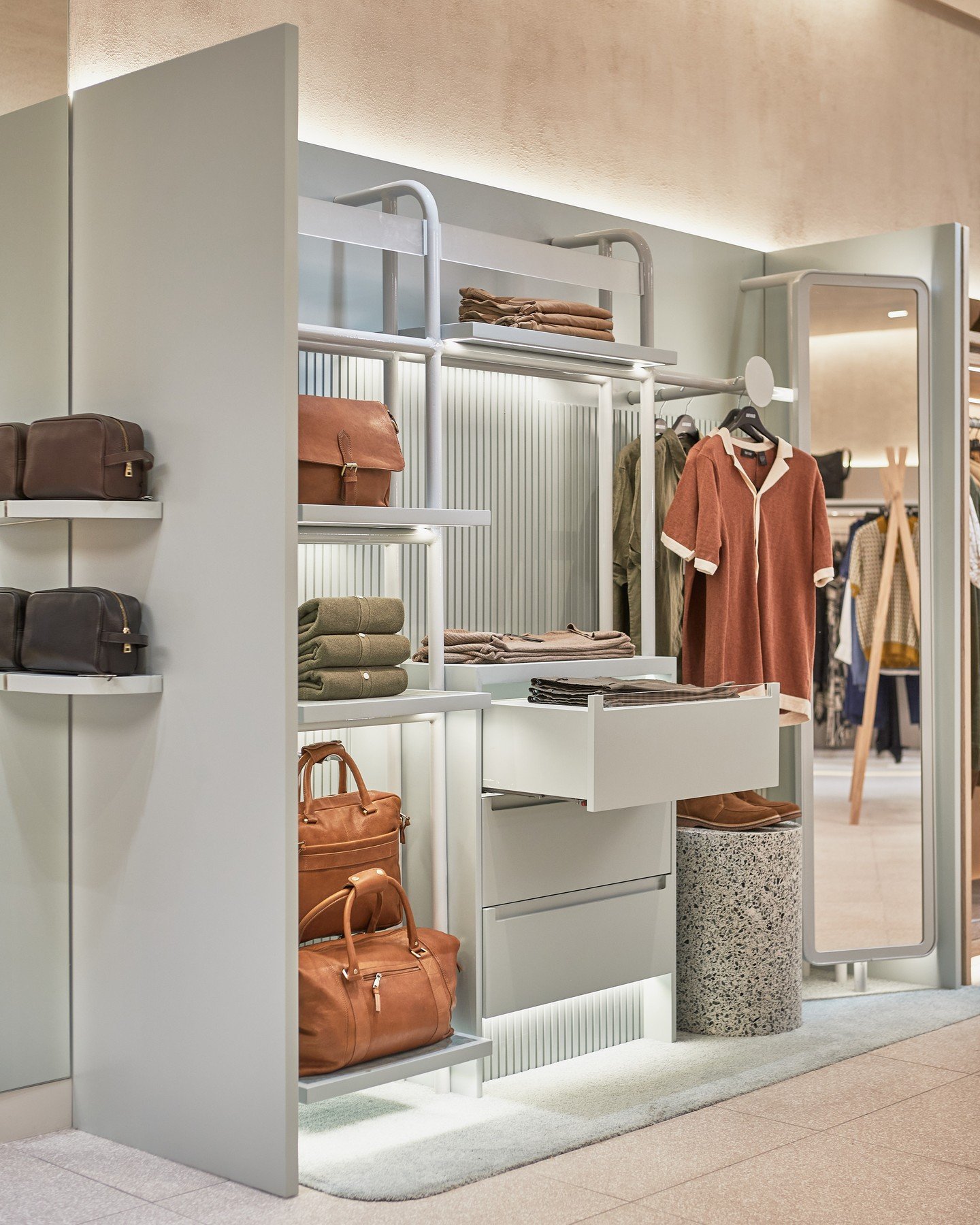 Oxford has transformed into a lively boutique experience! The men's section now features warm wood and pastels, while the women's area is chic and elegant with playful touches.The fitting rooms add vintage vibes with unique patterned wallpaper, while