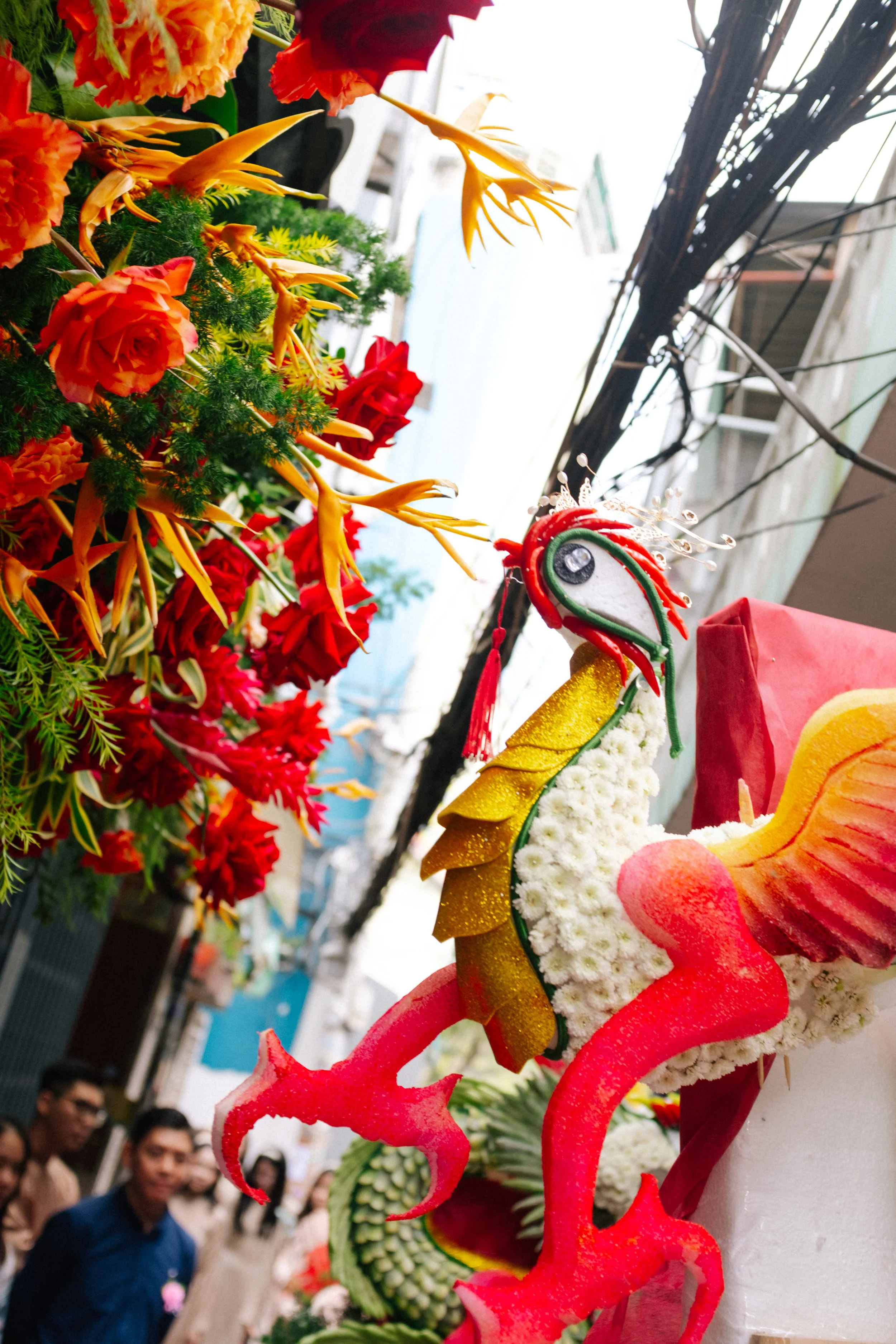 Colorful dragon and flower decorations on display at a street festival.