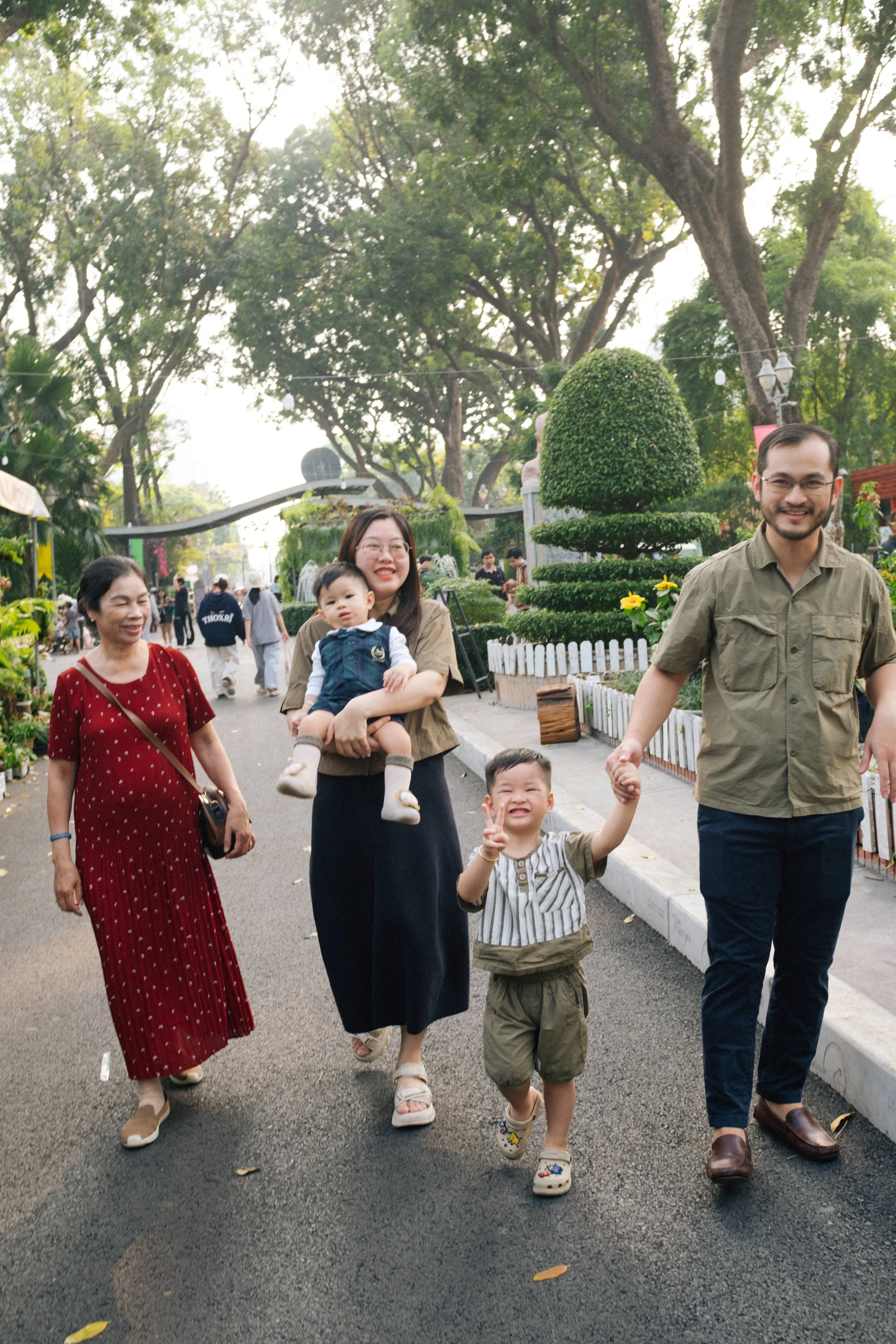 FamilyEnjoying a day outdoors with lush greenery and trees in the background.