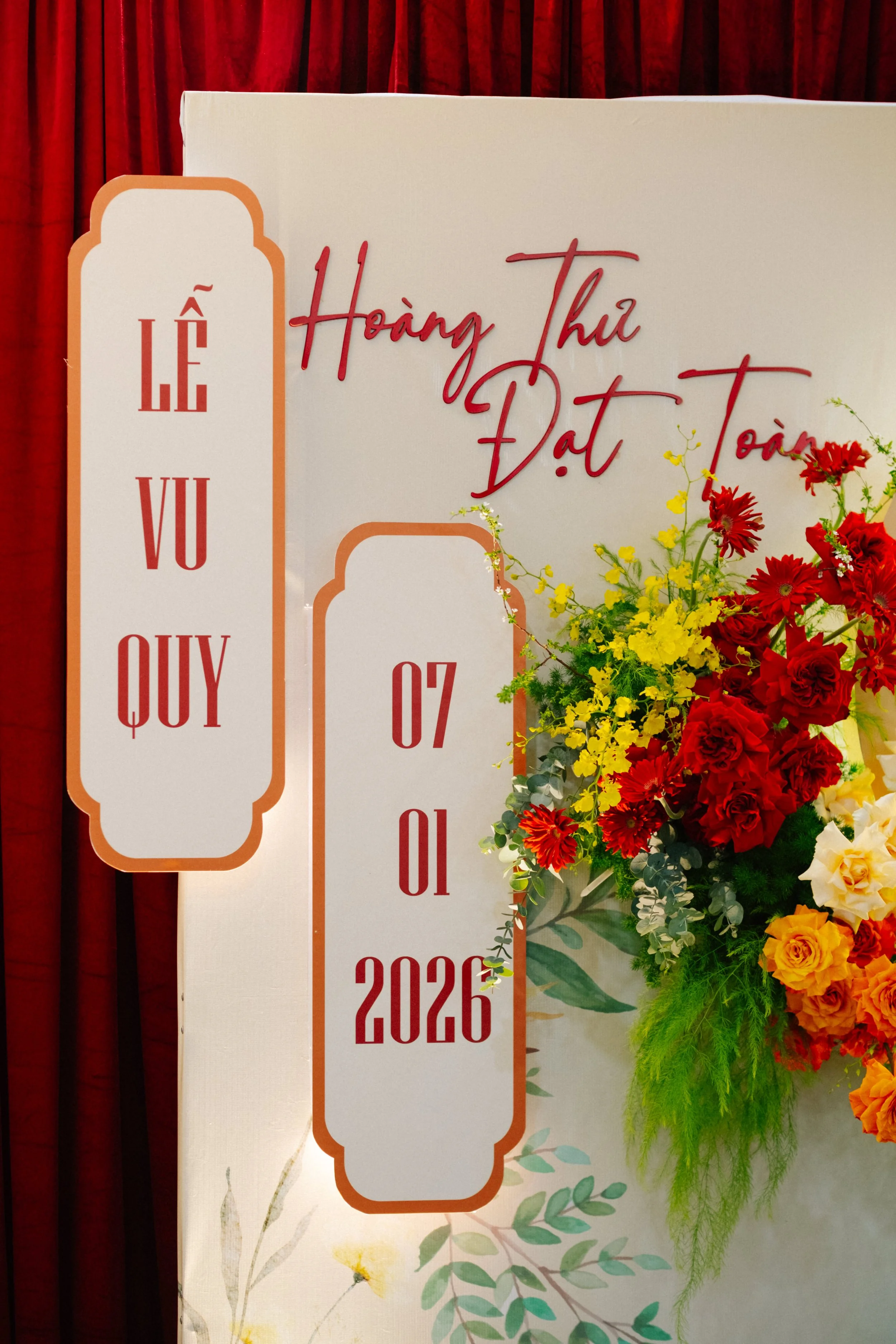 Flowers and sign at a Vietnamese wedding celebration with date 07/01/2026.