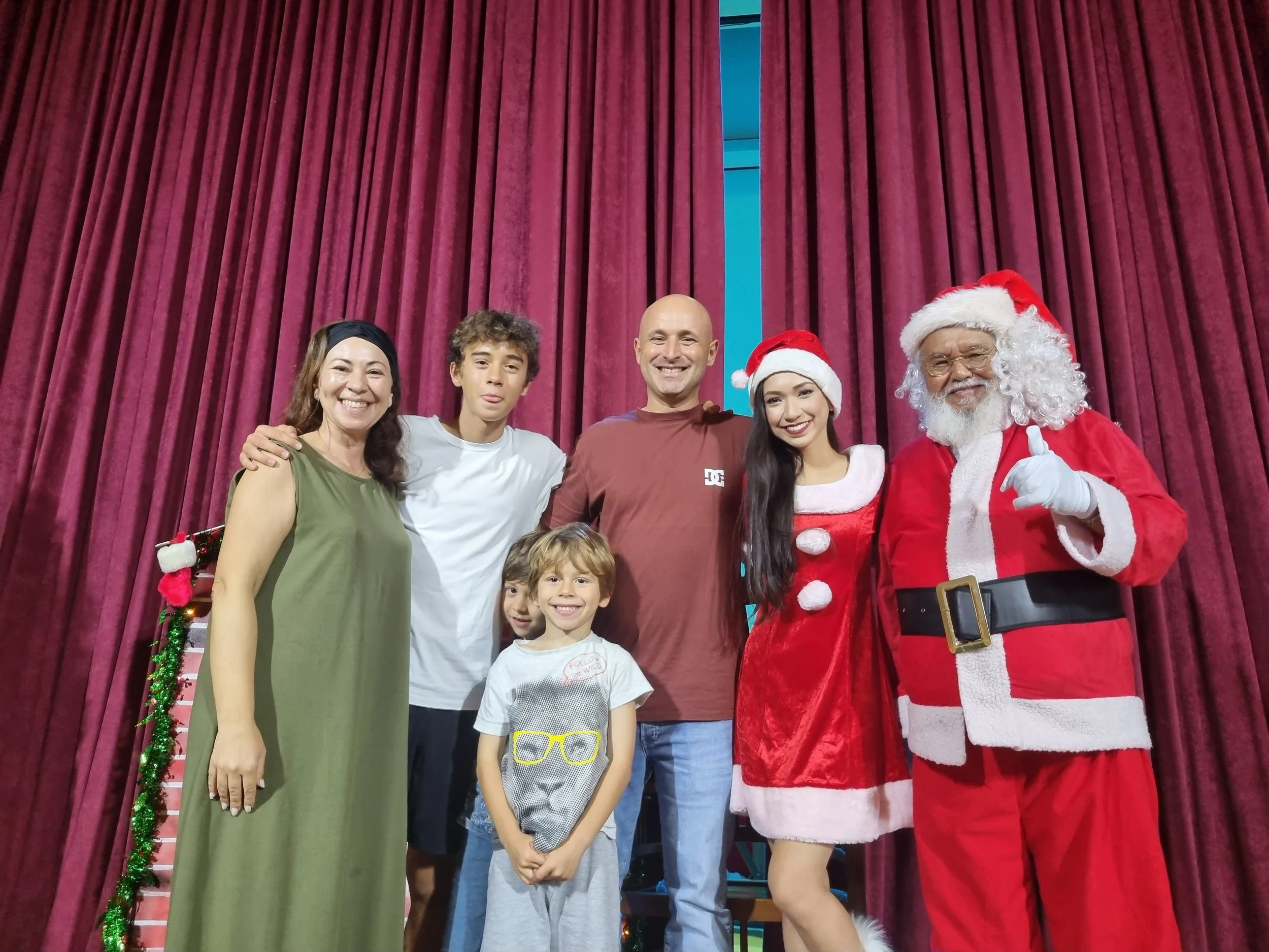 Percival Shepherdson (EA MC member aka Santa), with Florabelle Beins (EA dancer and Santarina), Nuno Pereira (President, Portuguese Association Singapore) and his family.