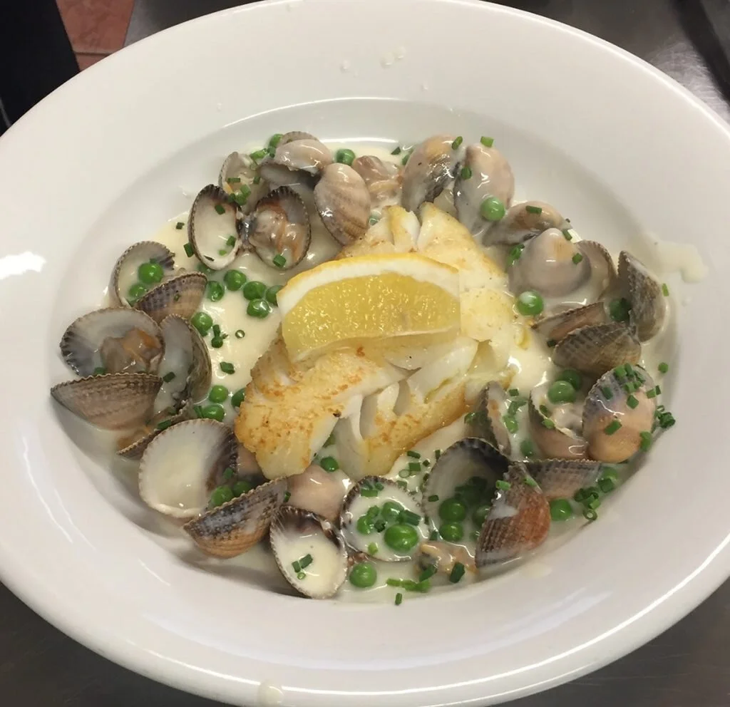 An-item-which-often-appears-on-our-Specials-board-Pan-fried-Killybegs-fillet-of-hake-with-peas-cockles-and-a-creamy-cockle-sauce-on-a-bed-of-mashed-potato-1024x992.jpg