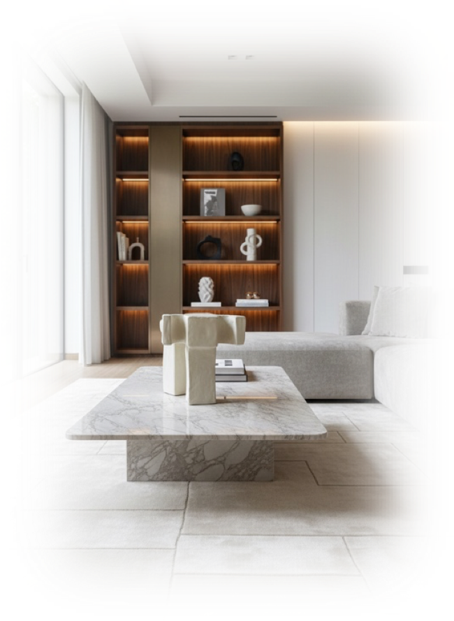 Sala moderna con muebles blancos, estantería de madera con objetos decorativos, y mesa de mármol en el centro.