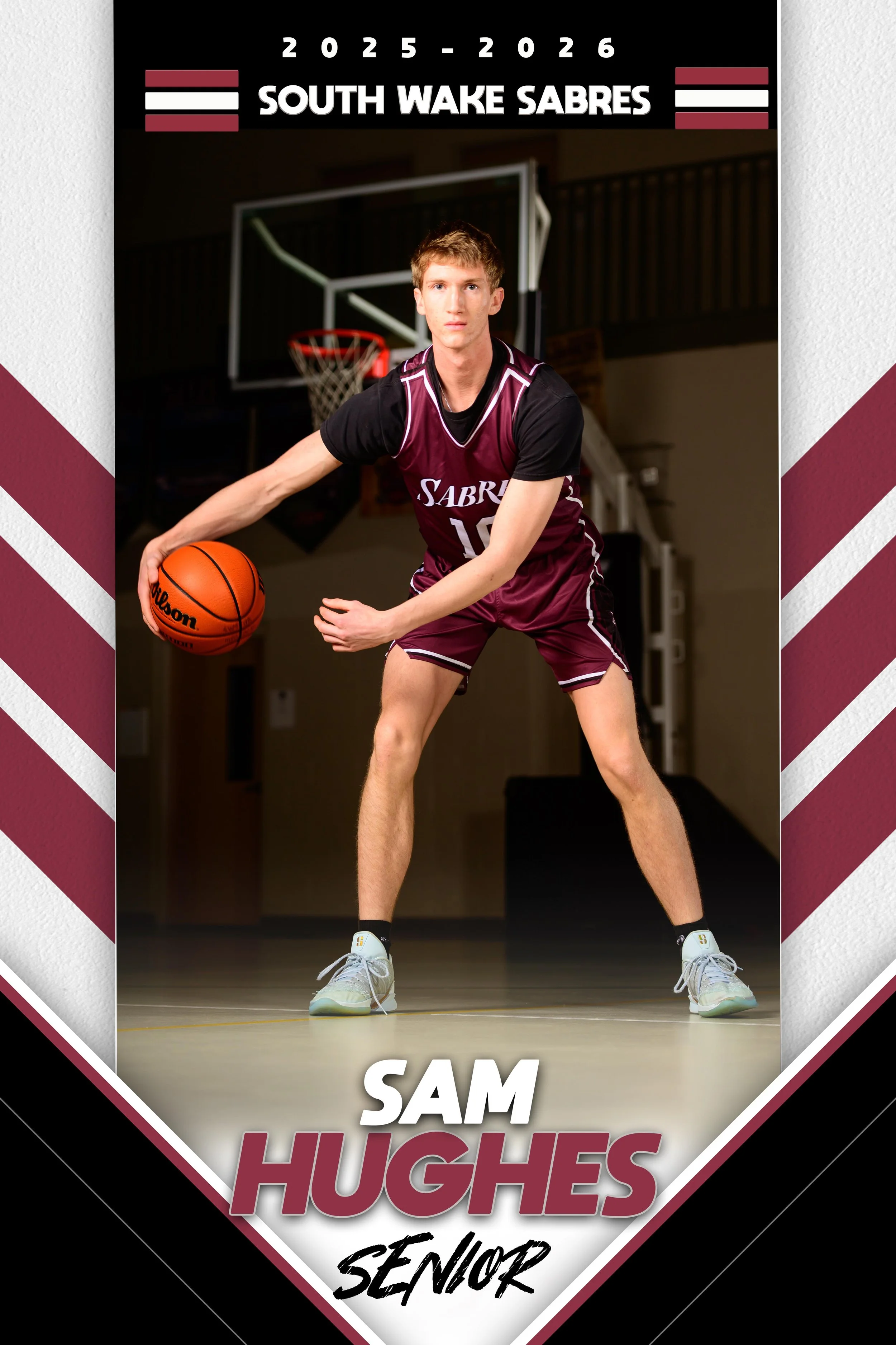 A high school basketball senior portrait of Sam Hughes wearing a maroon and black basketball uniform, holding a basketball on an indoor court with a basketball hoop in the background, featuring team name South Wake Sabres and a 2025-2026 banner.