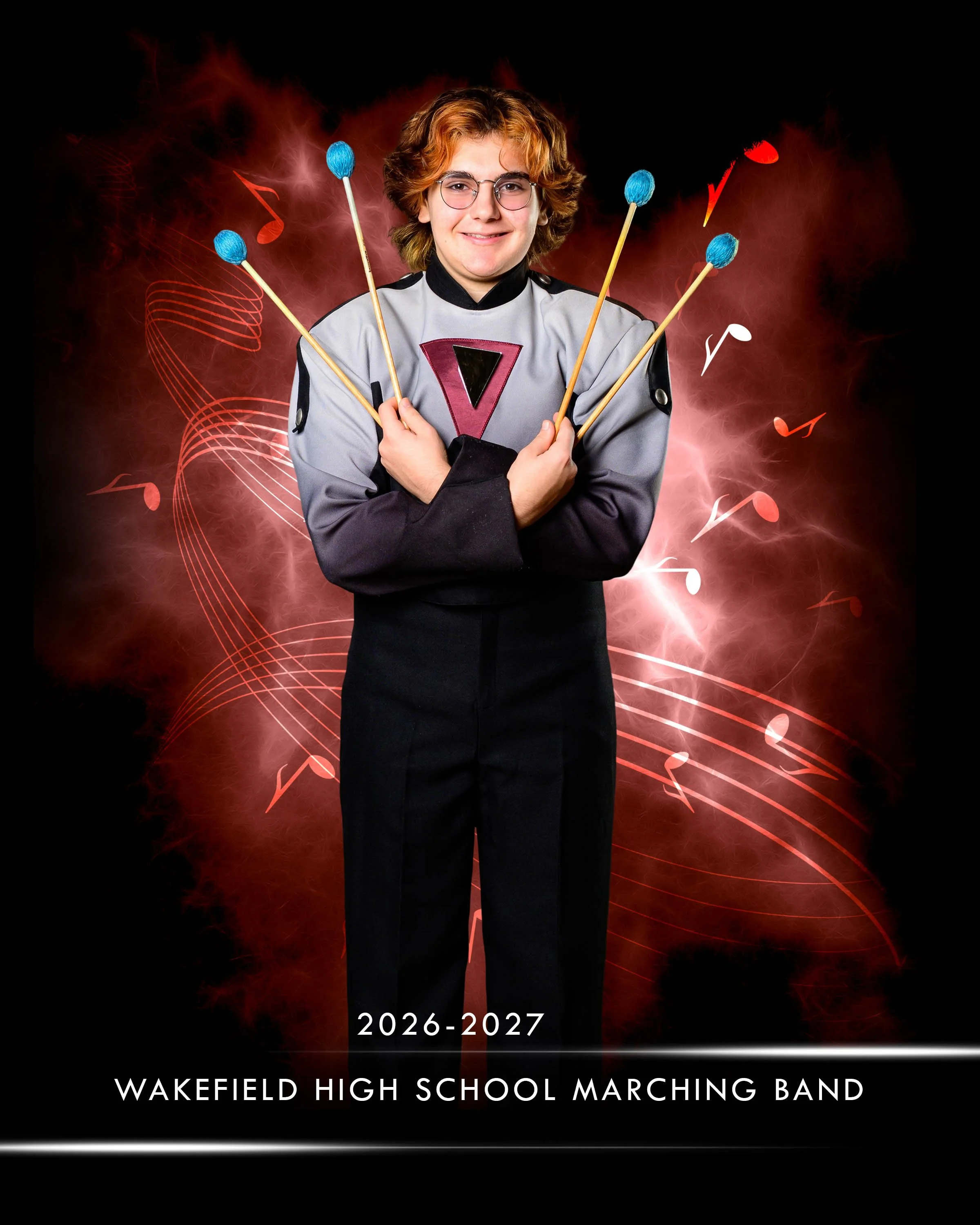 A person with curly, light brown hair and glasses, dressed in a marching band uniform, holding drumsticks with blue tips, standing in front of a red and black abstract background with musical notes, with the text '2026-2027 Wakefield High School Marc