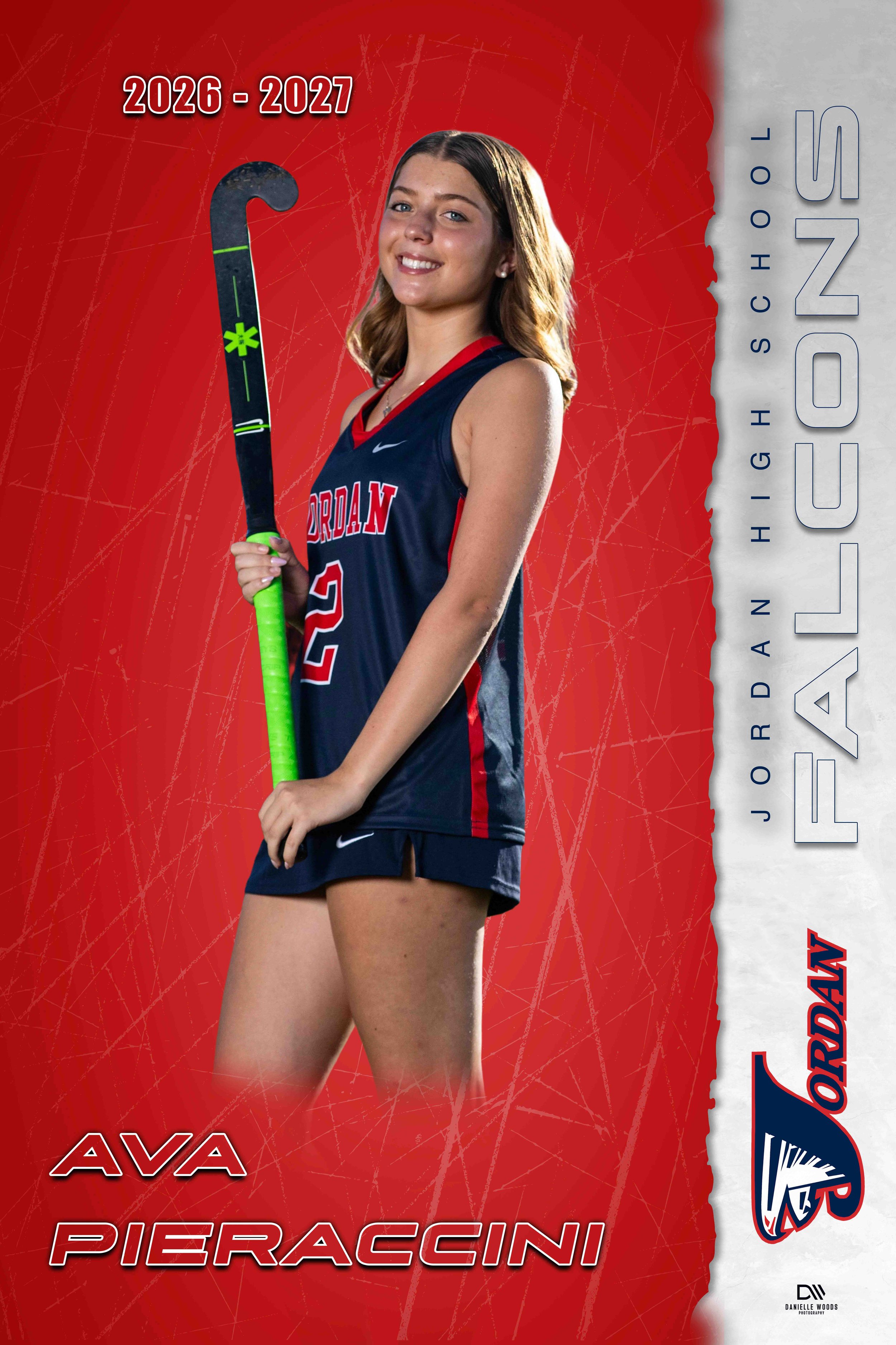 A young woman in a dark blue volleyball uniform holding a hockey stick, standing in front of a red background with white and blue text that says "AV A PIERACCINI". The top left corner shows the years 2026-2027. The right side has the name "JORDAN HIG