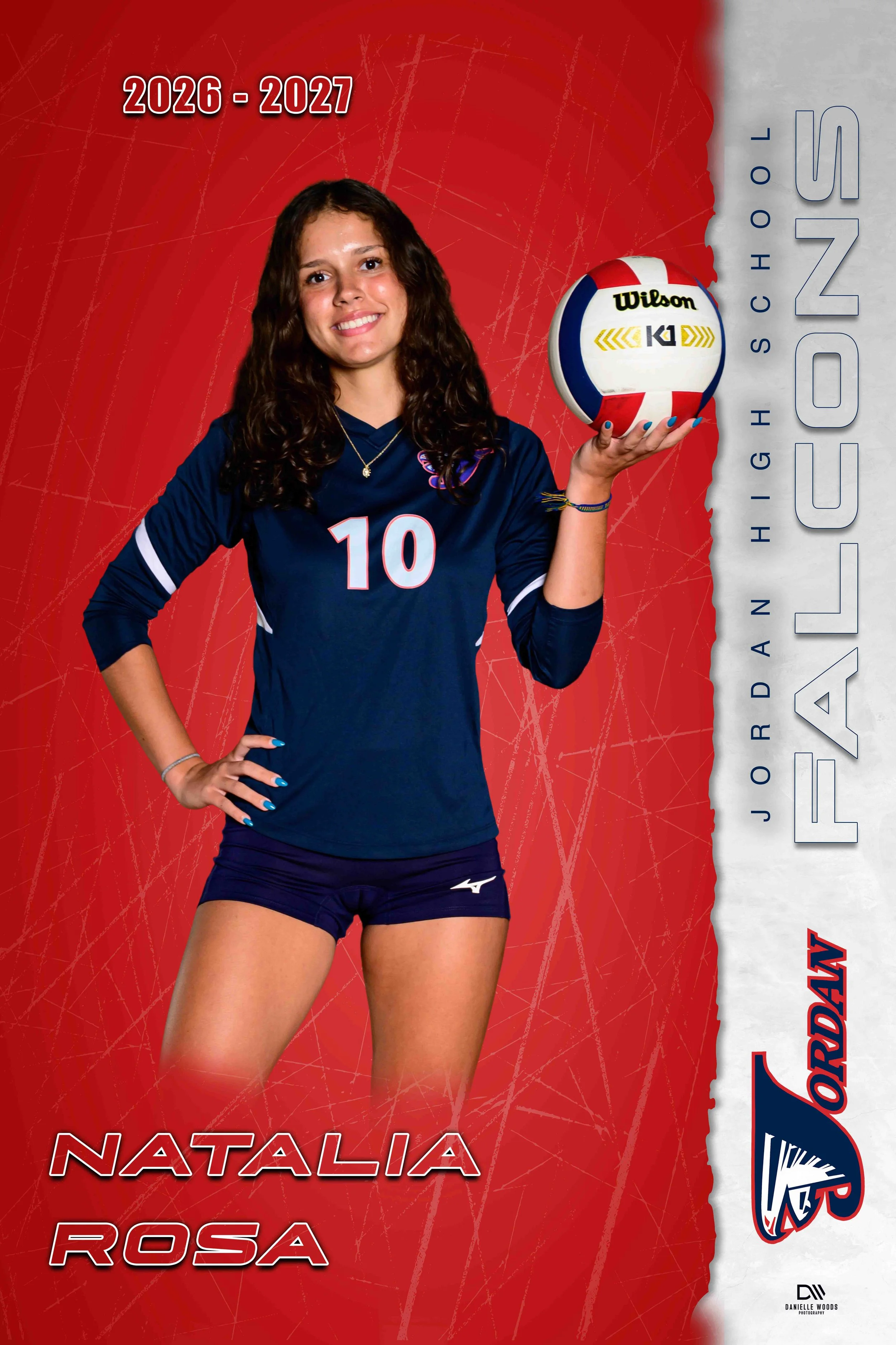 A young female volleyball player with curly brown hair, wearing a navy blue sports jersey with the number 10, and holding a Wilson volleyball. Behind her is a red background with a textured pattern, and white text featuring the years 2026-2027, the n