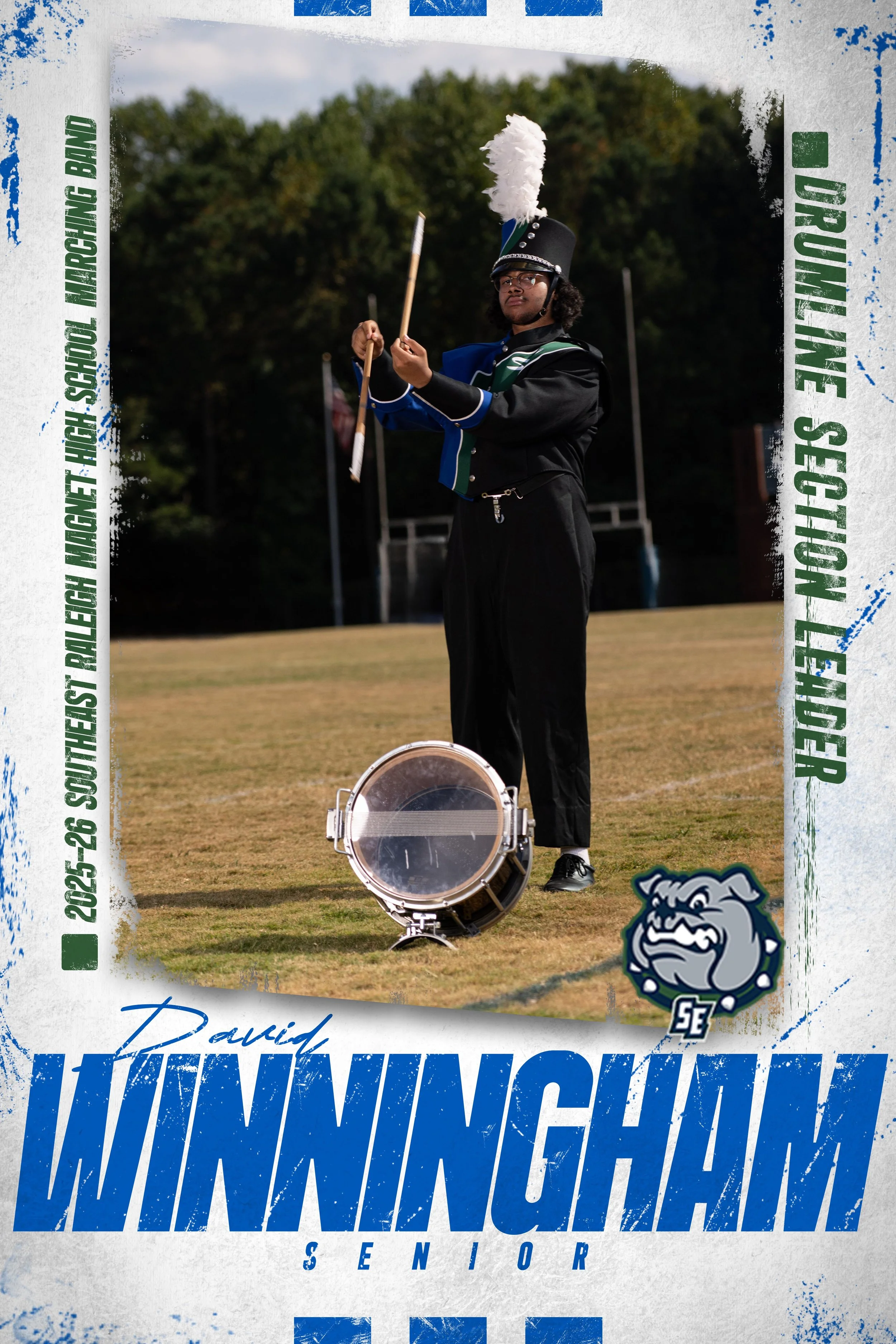 A senior marching band member in uniform standing on a field, holding a flag, with a drum on the ground in front. The image has a graphic overlay with text and a bulldog mascot, indicating it is from a senior celebration for Winningham.