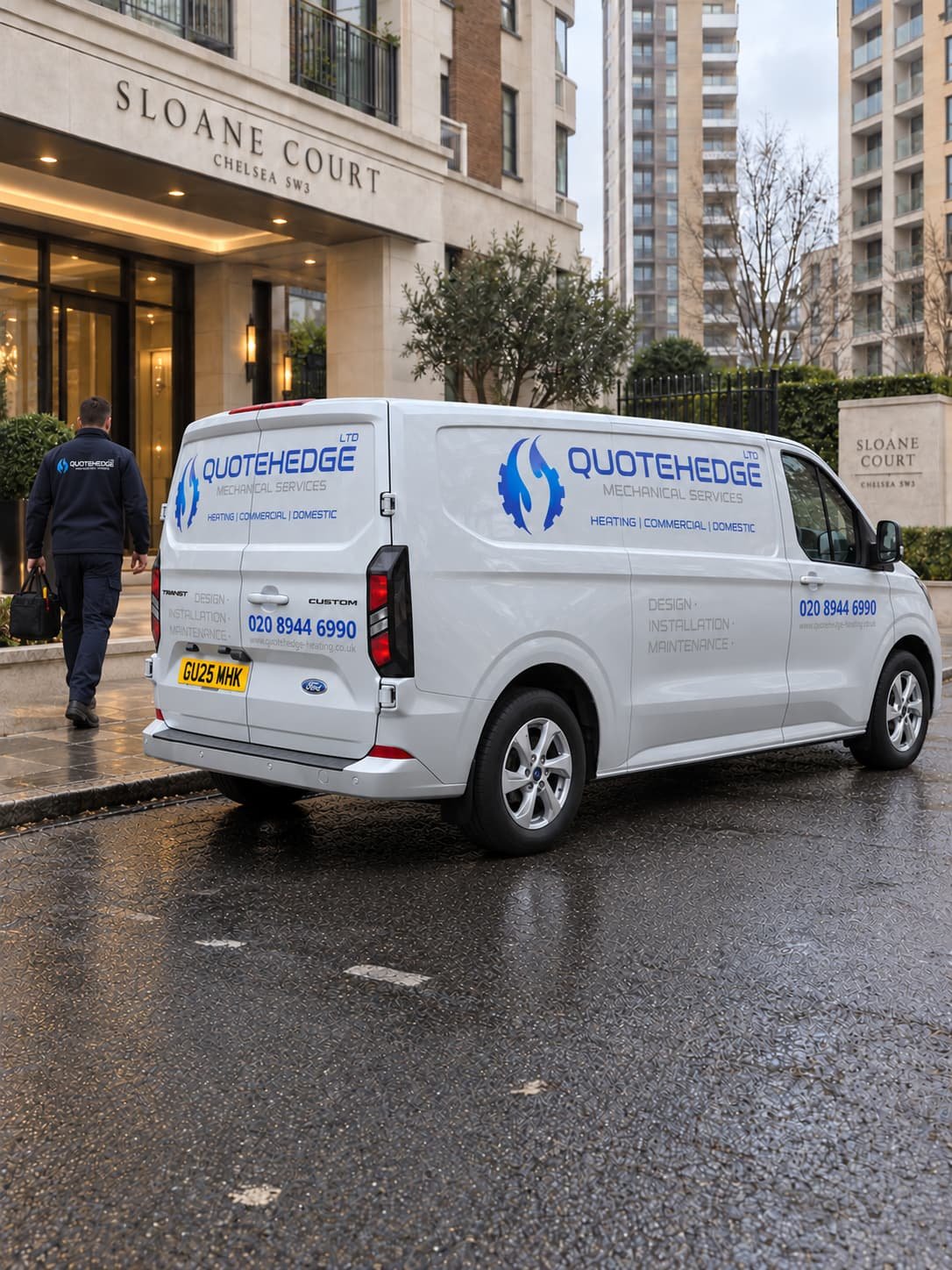A white QuoteHedge Mechanical Services van parked on a wet street in front of a building labeled Sloane Court.