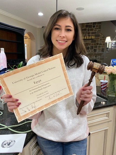 Ashlyn with her outstanding delegation award from the University of Georgia’s Model UN conference.