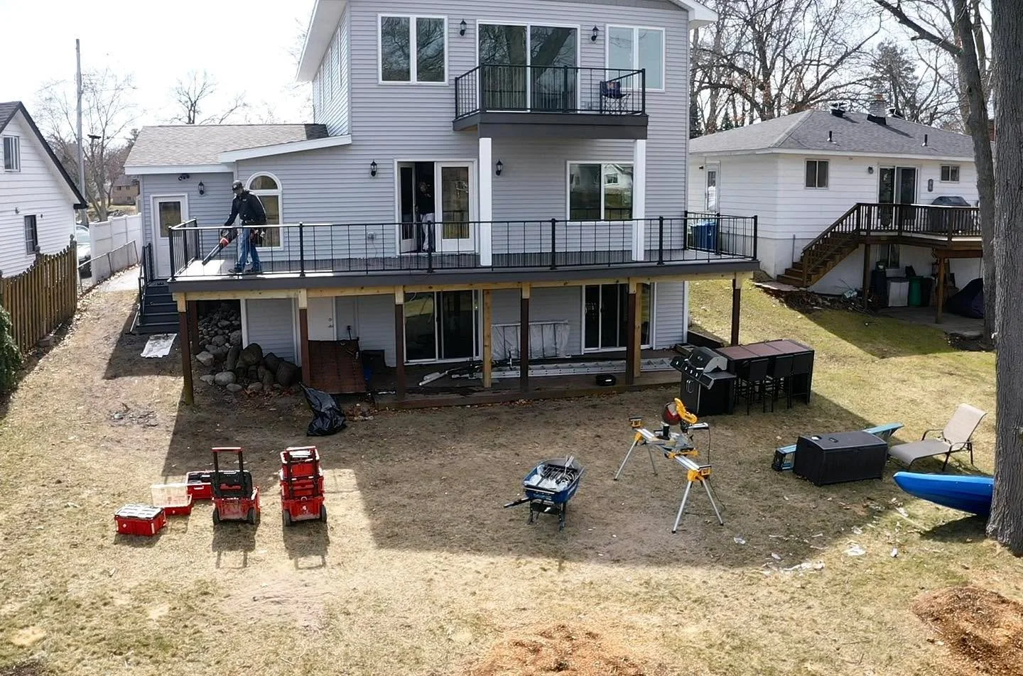 Final touches to this lakeside beauty! 
Earl gray composite deck overlooking Lake Oakland features a master suite balcony, single board picture frame with nosing on the deck and steps, double board mid-deck divider, and sleek Westbury Verticable rail