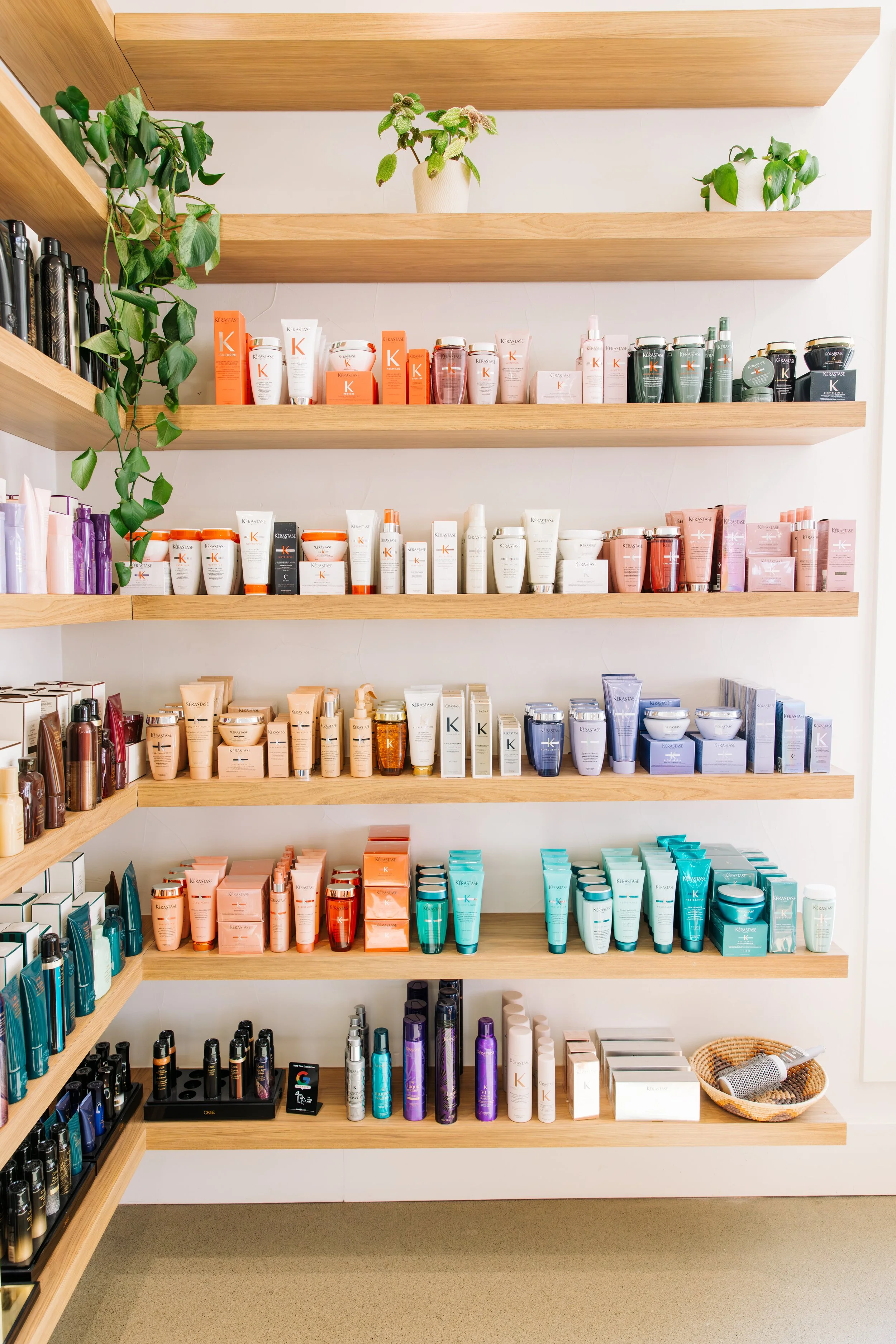 Display of colorful bottles of KÉRASTASE hair care and styling products