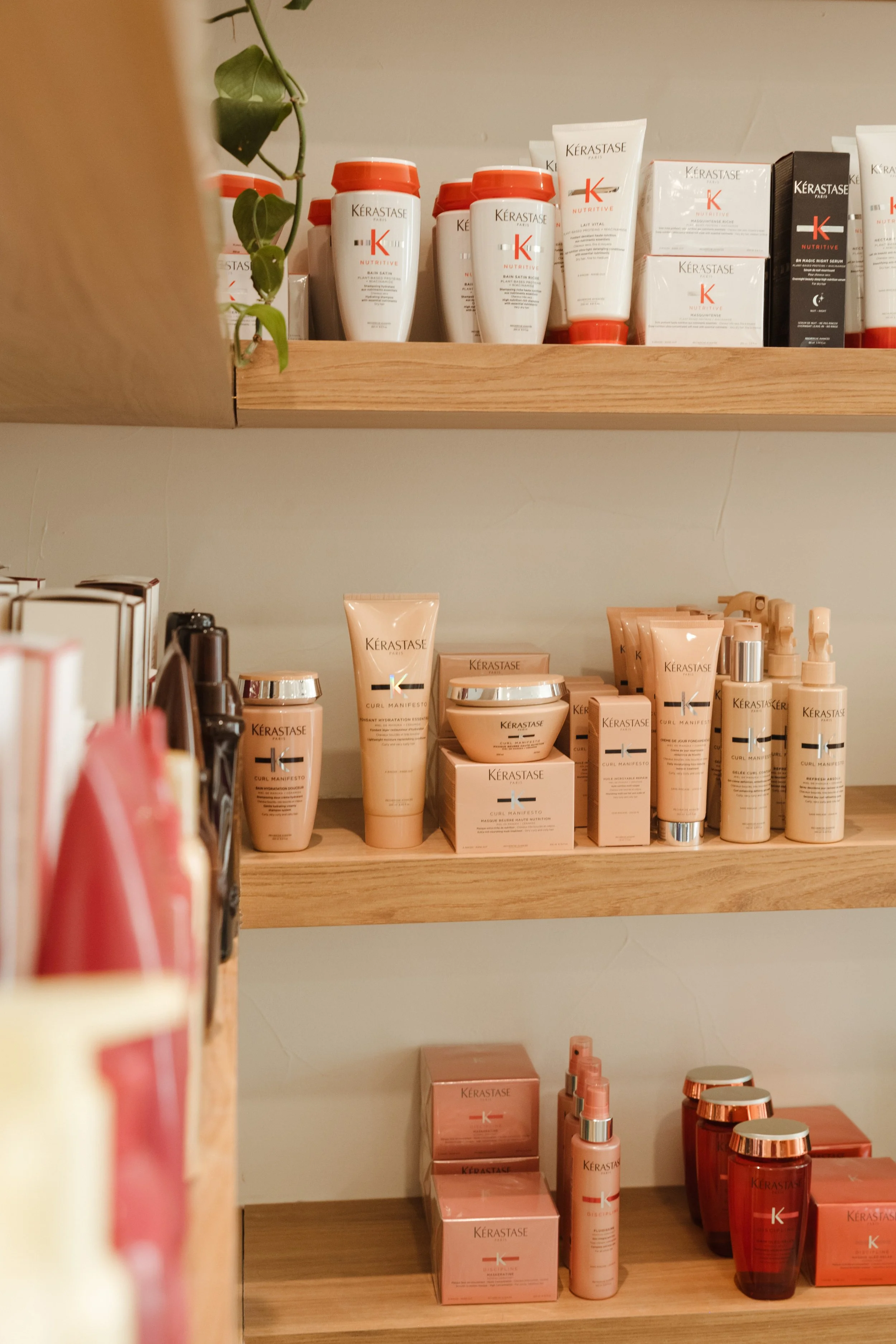 Display of colorful bottles of KÉRASTASE hair care and styling products