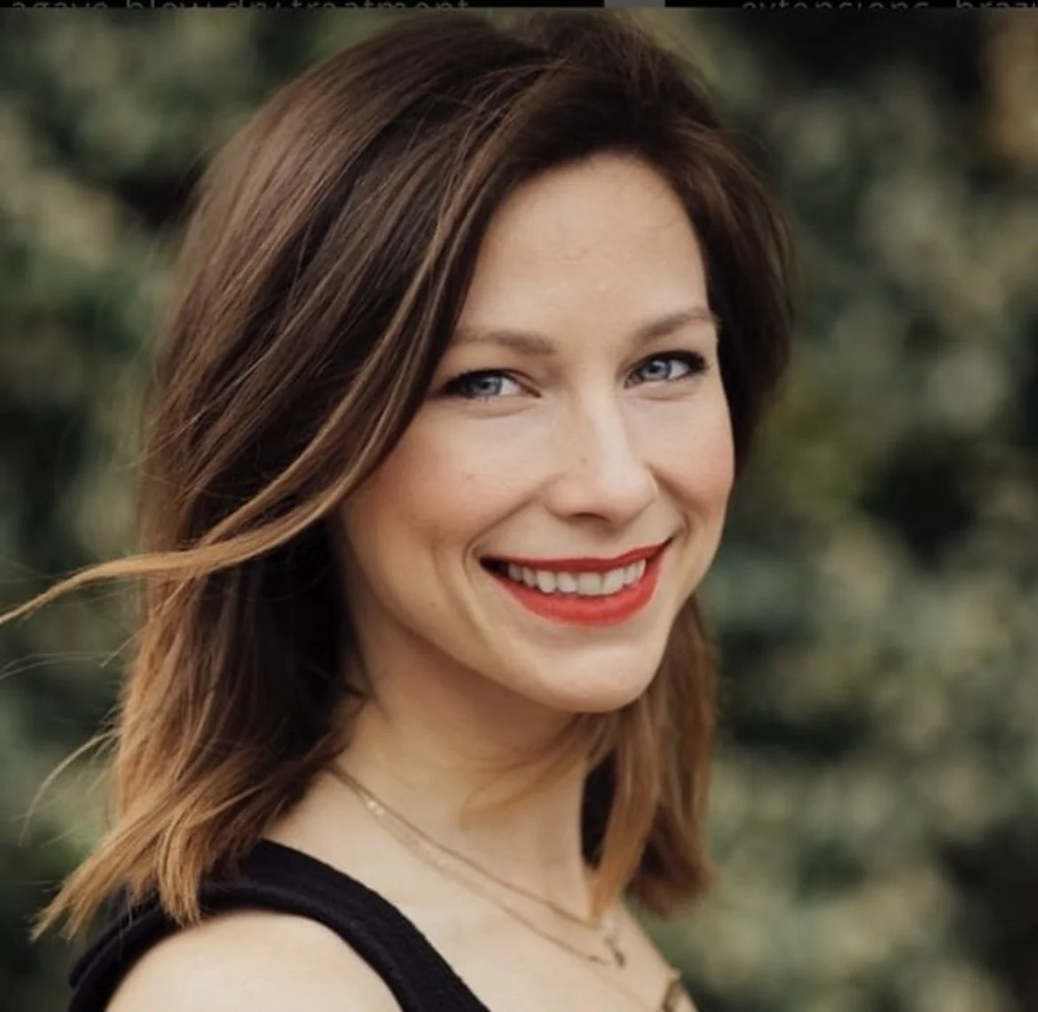 Headshot of smiling hairstylist with brown hair