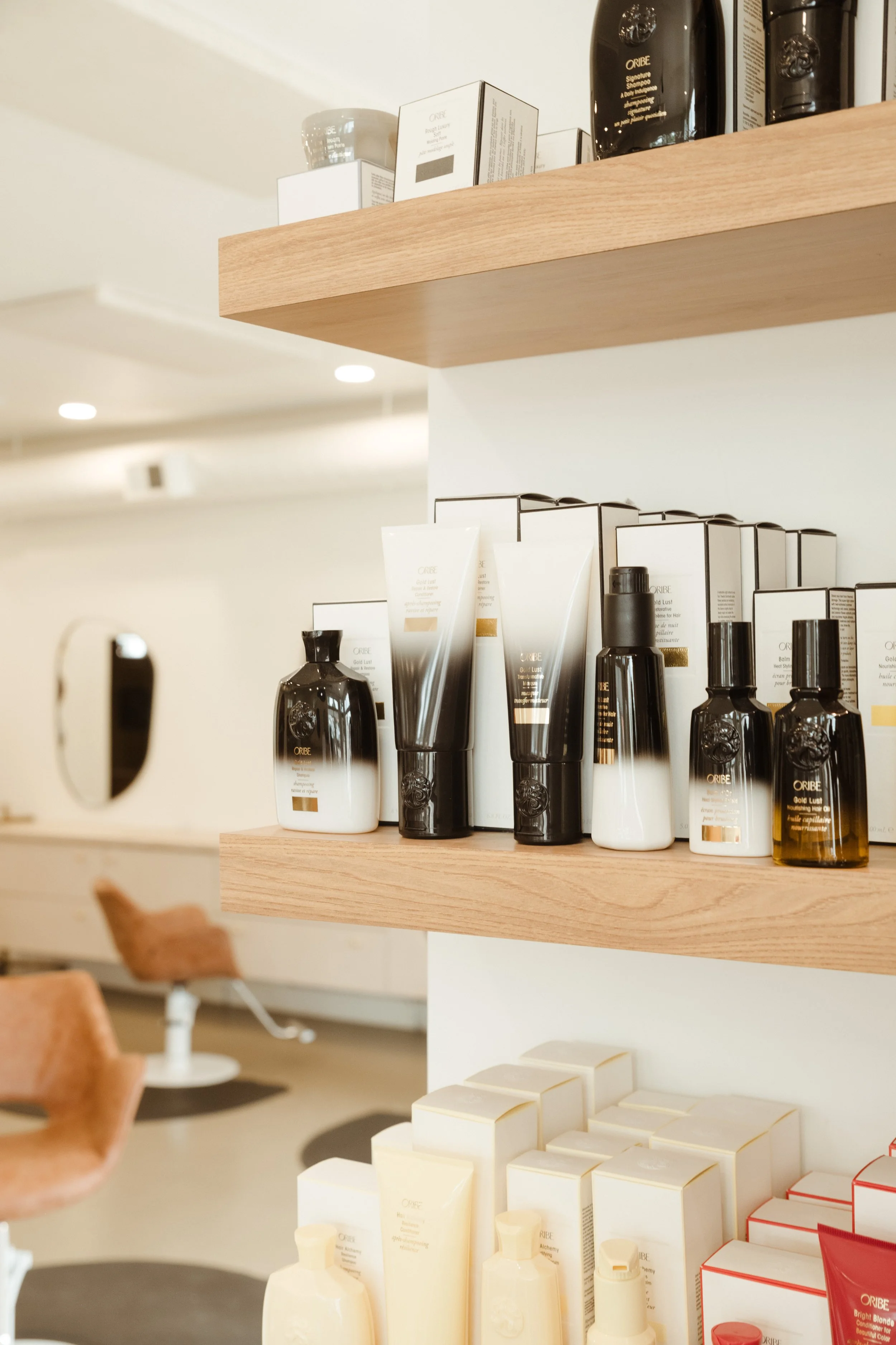 Salon shelves displaying brightly colored Oribe hair products