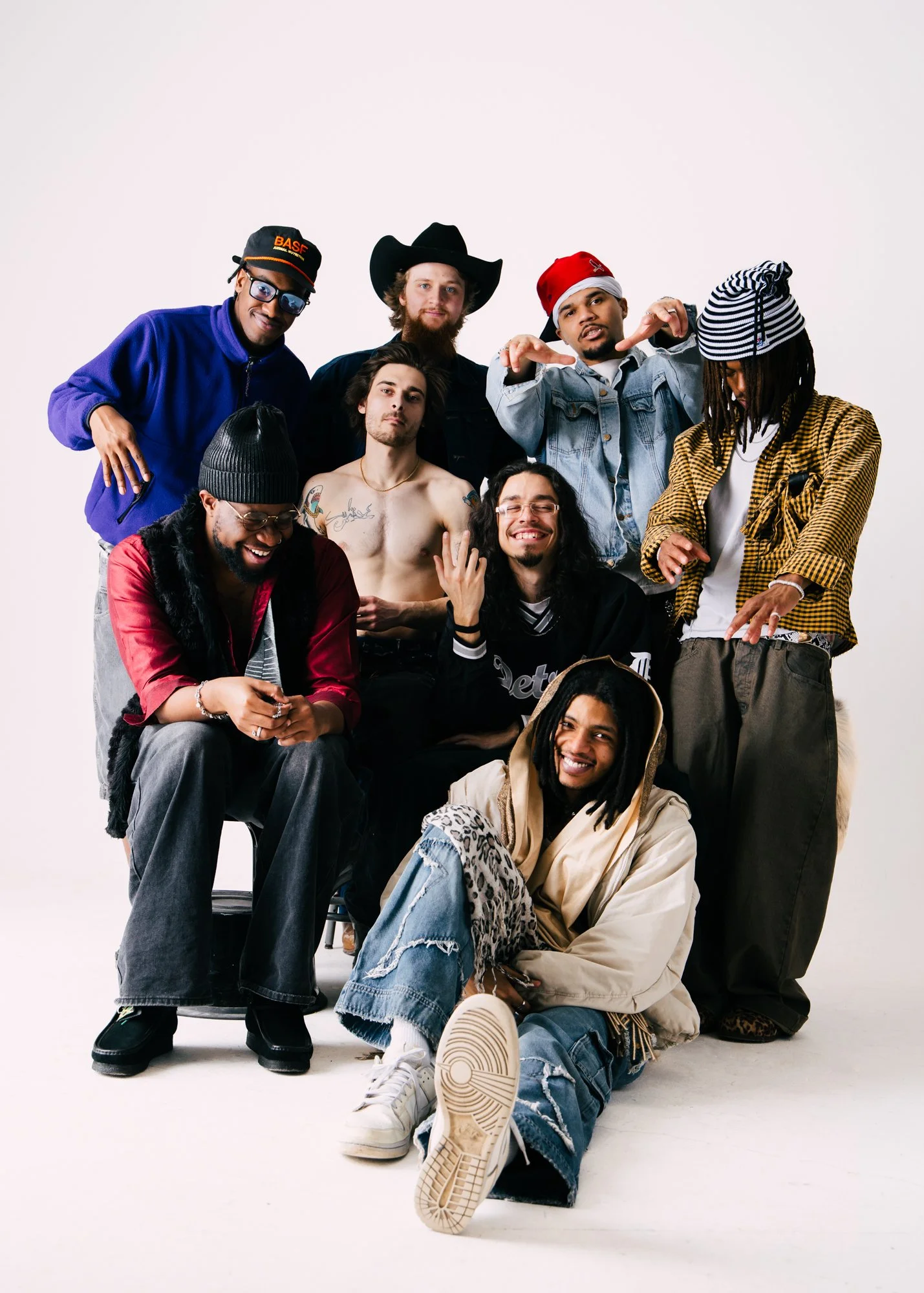 Eight guys, Hip-Hop group, varied posing and styling, studio, white background.