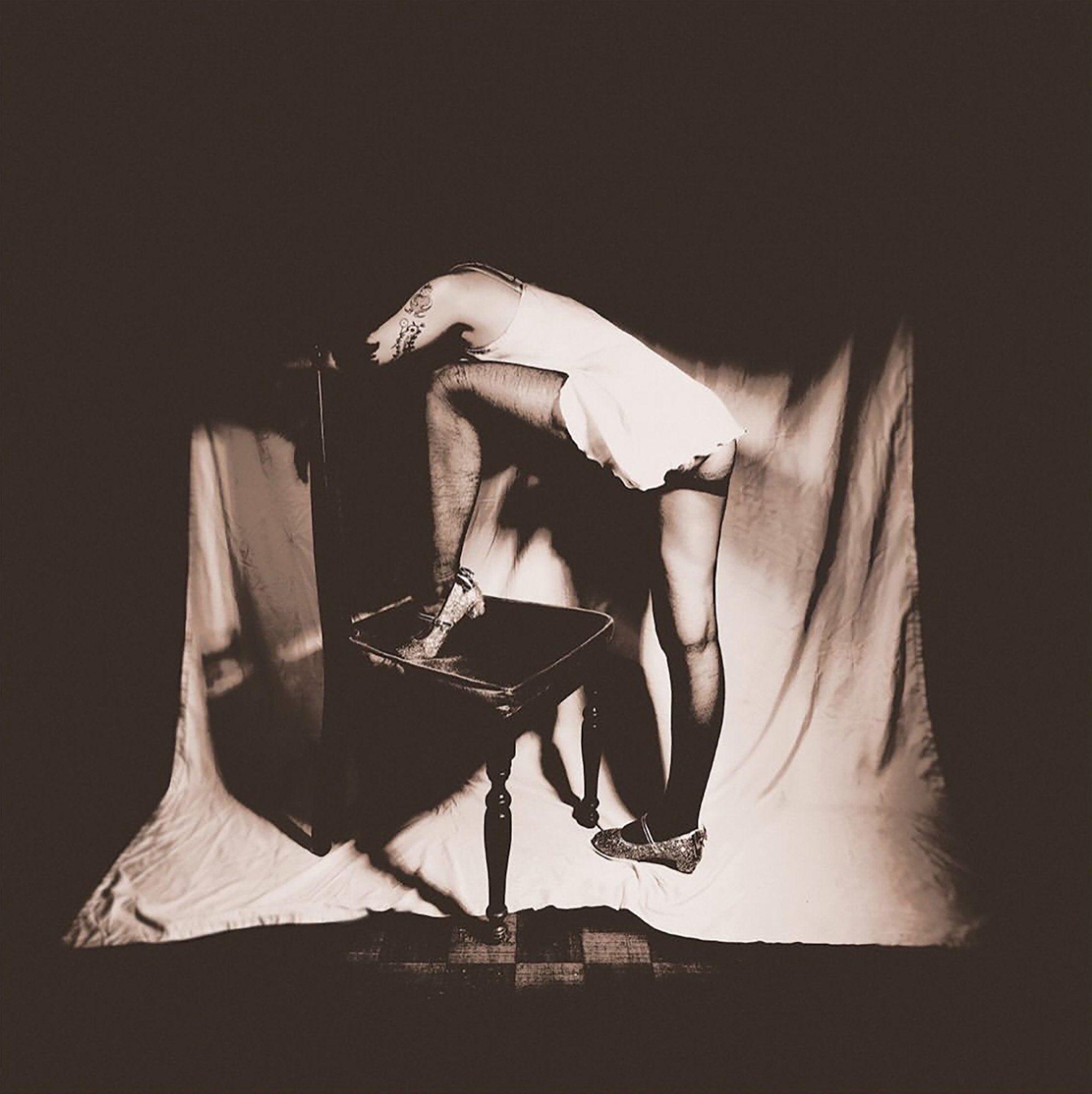 Fine art faceless hidden fashion with leg on chair