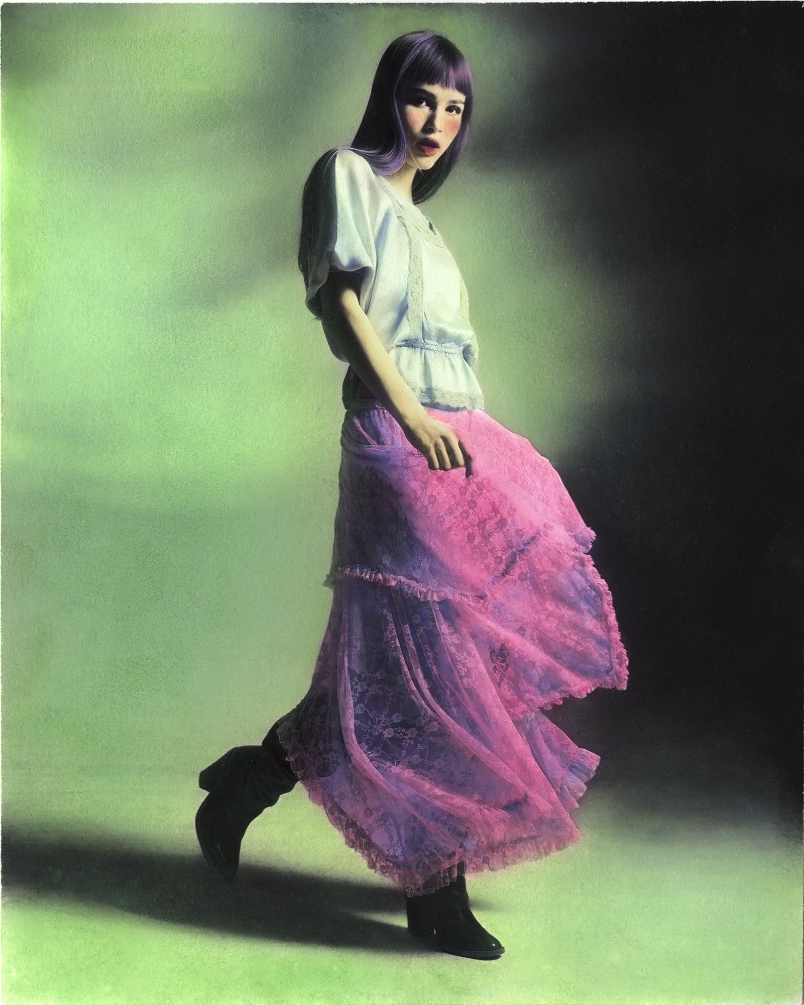 Woman looking at camera, wearing teal blouse, purple skirt and boots, walking in green studio, hand coloured