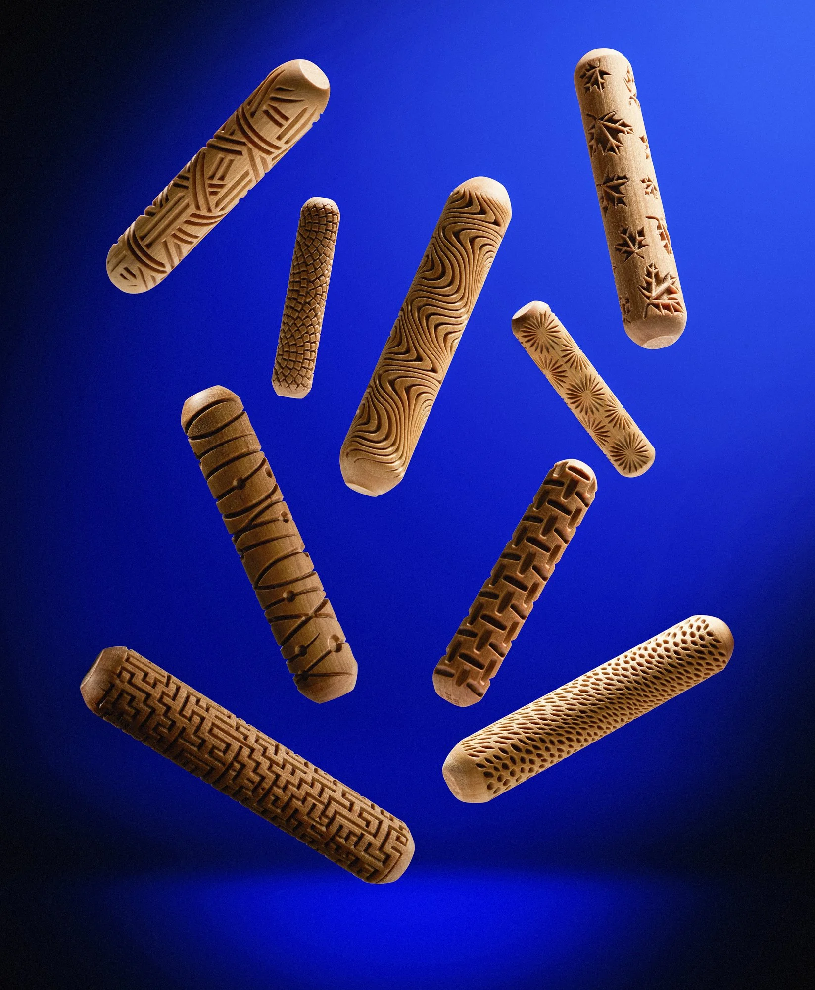 Textured Wooden Rollers floating in blue scene, directional lighting.