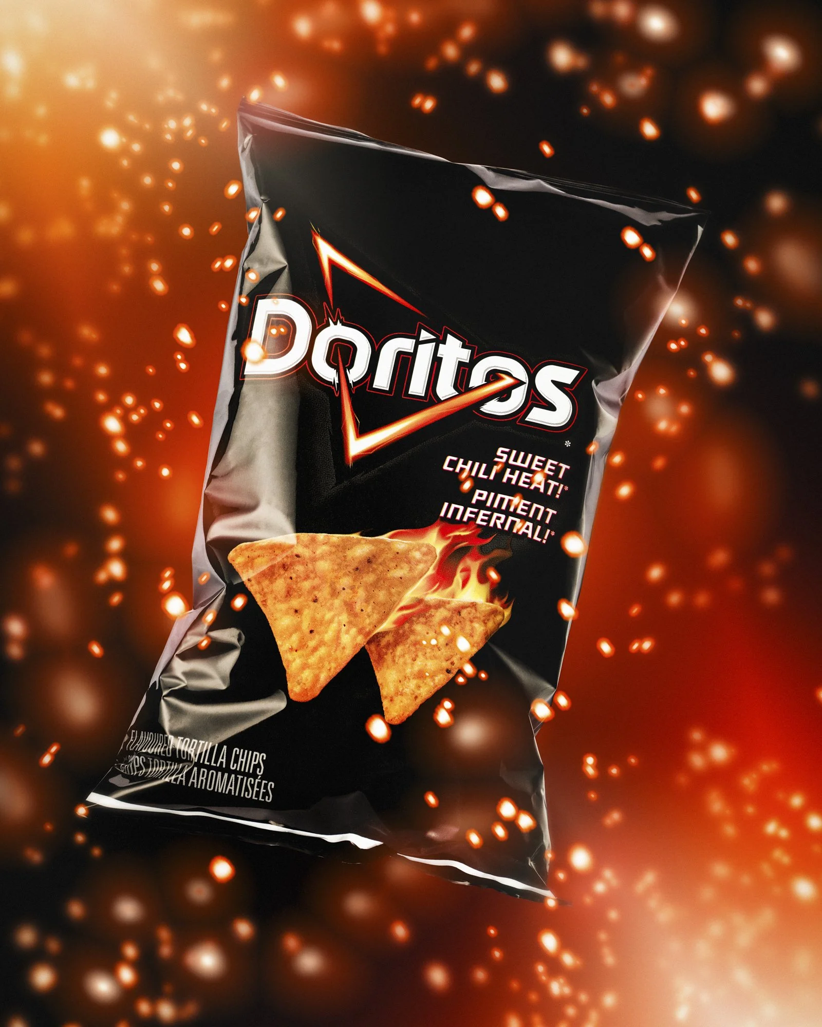 Black Sweet Chili Heat Doritos bag floating in darkness, surrounded by glowing embers and fiery sparks.