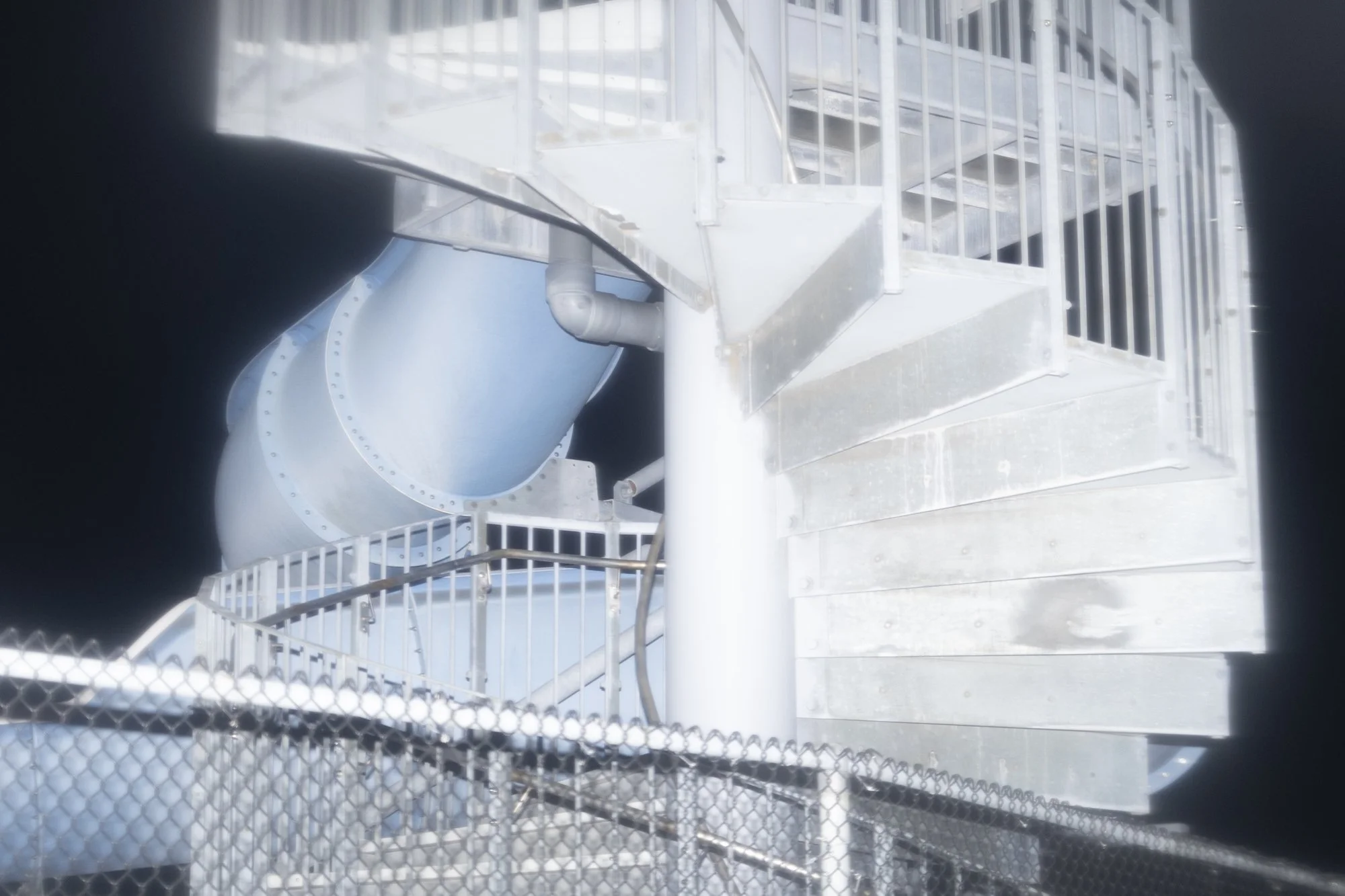Close up blue water slide, night time shot, flash.