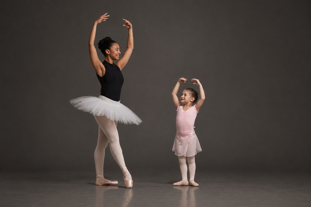 Older dancer mentoring a preparatory dancer