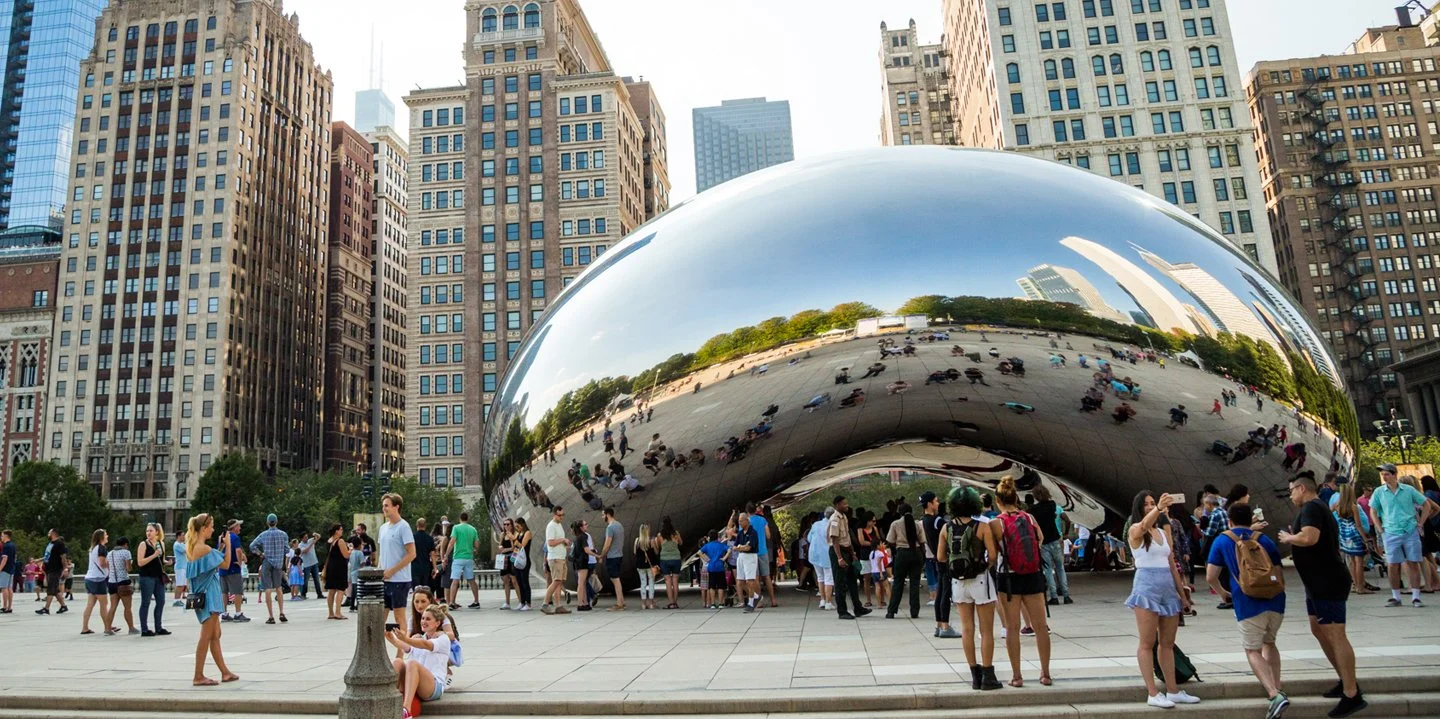 Visitors exploring Cloud Gate in Chicago’s Millennium Park