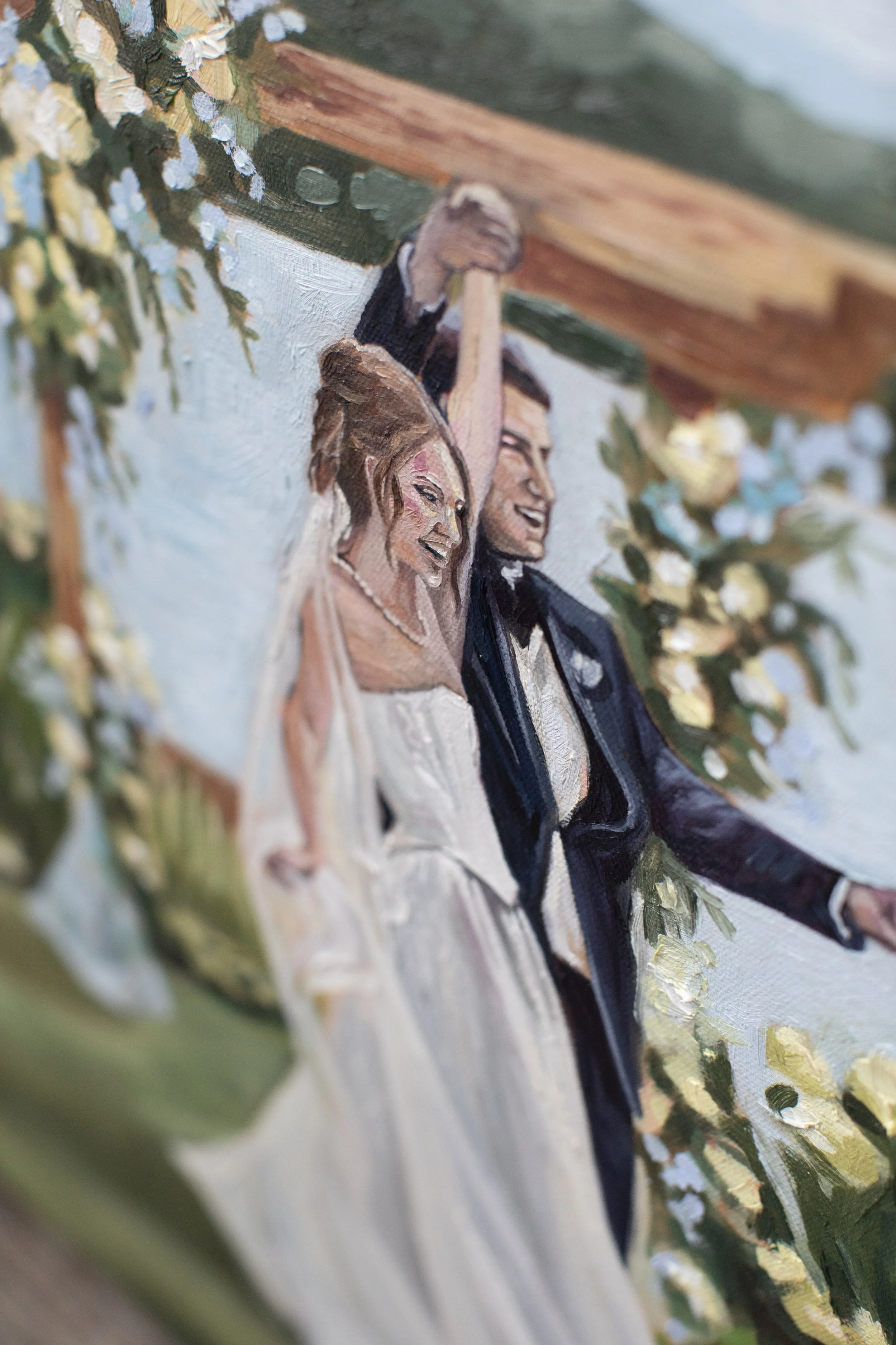 A painting of a bride and groom at their wedding, smiling and holding hands, with greenery and flowers around them. A detail of a live painting in Buffalo NY