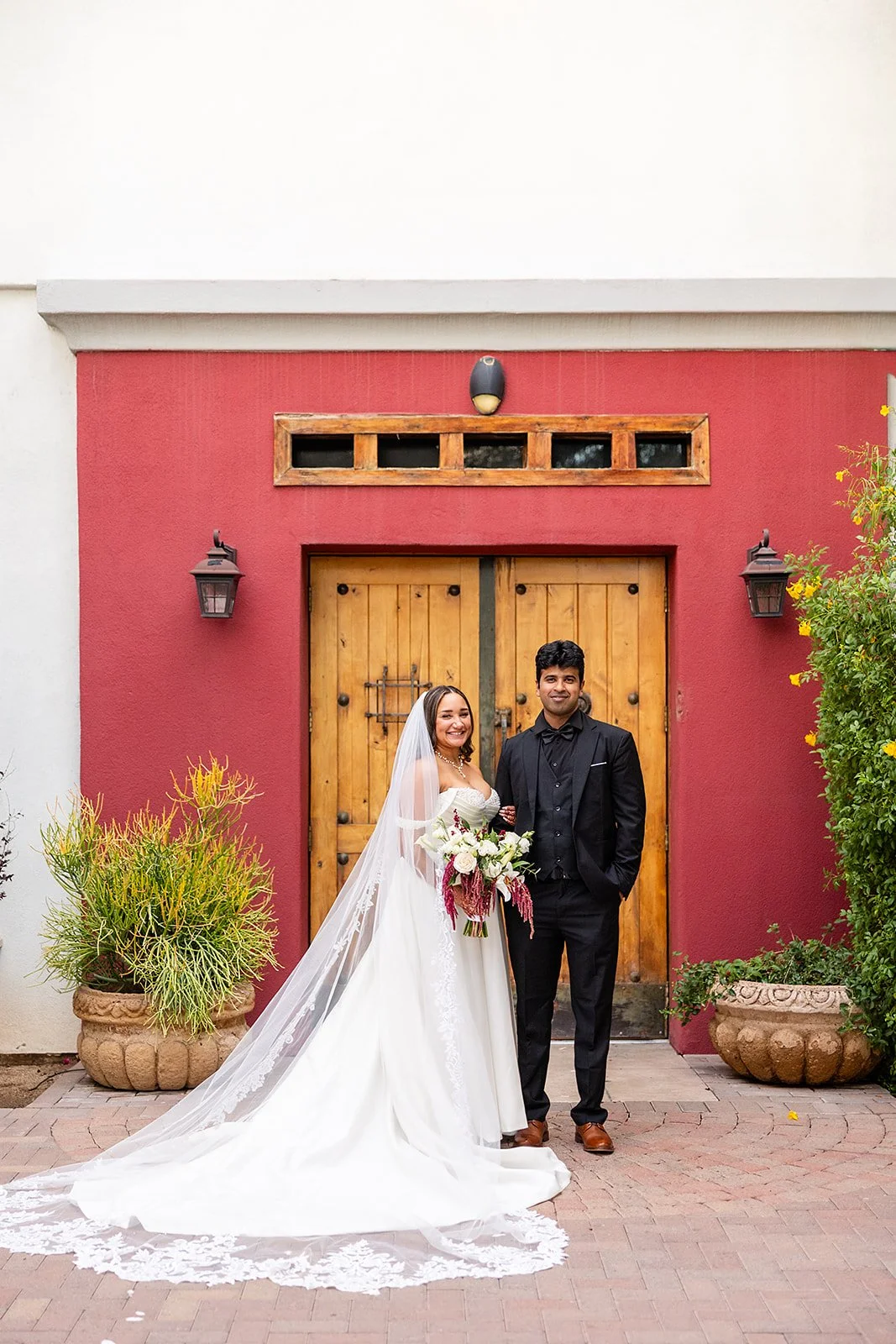 bride and groom smiling at the camera