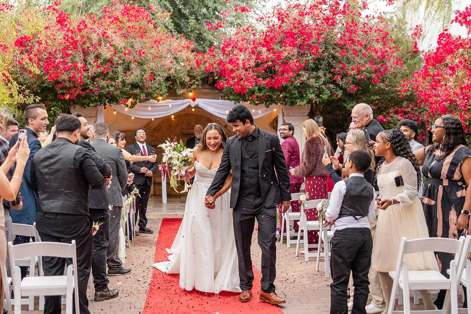 the bride and groom walking down the aisle at the cermeony