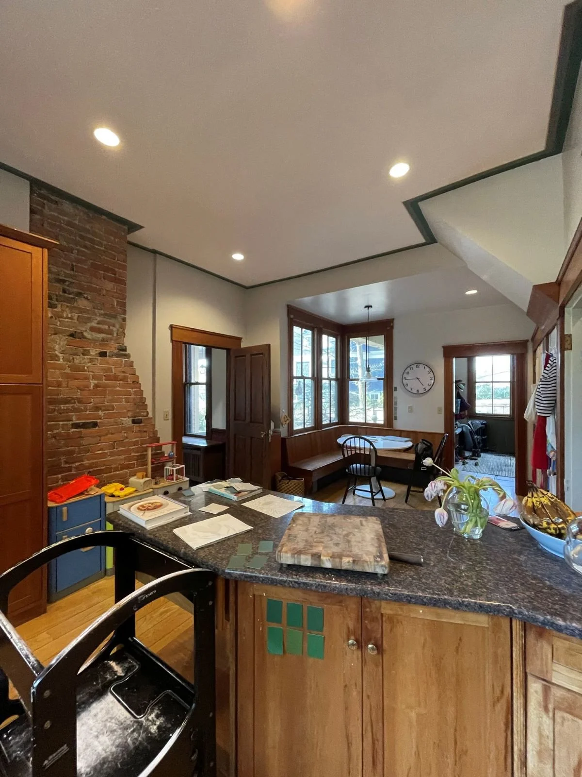  Existing kitchen chimney of an 1846 Victorian home in Newton MA prior to renovation showing original brick chimney separating kitchen and dining room before removal and reconfiguration