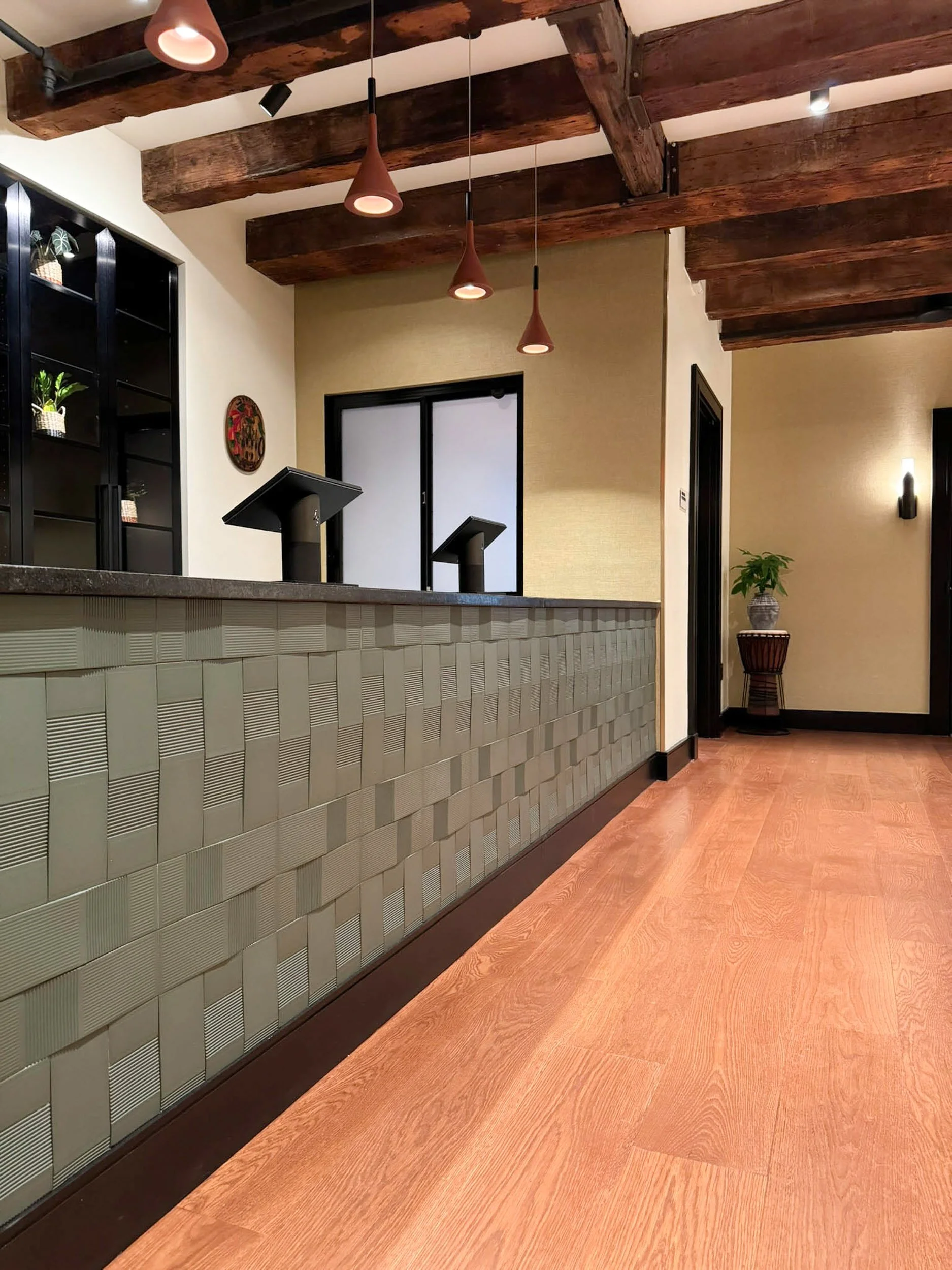 Detail of green texture tile installed in a woven pattern at a custom POS counter in a Boston retail building.