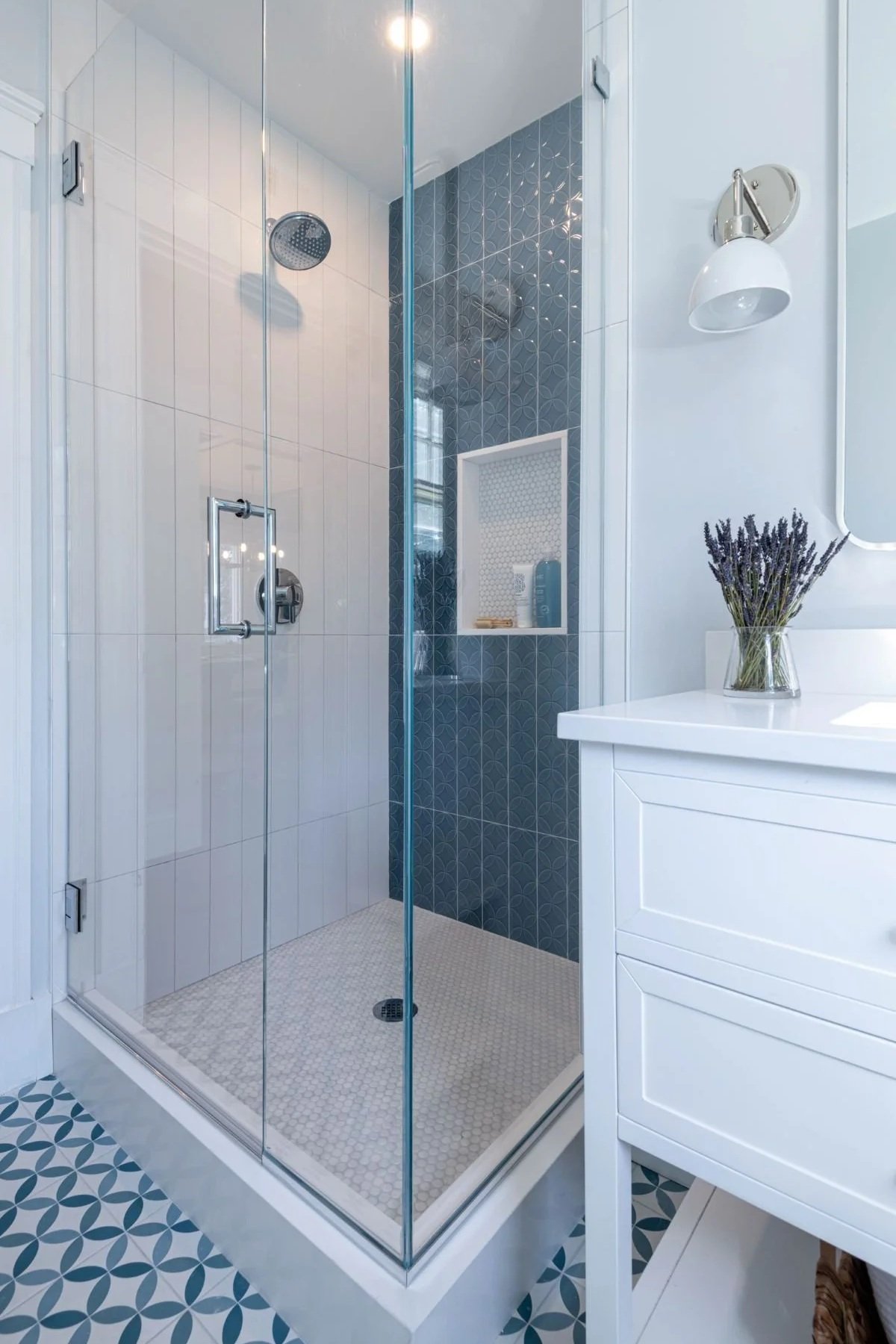 A sizeable walk-in shower in a Medford secondary bath, created by claiming underutilized square footage from an adjacent linen closet.