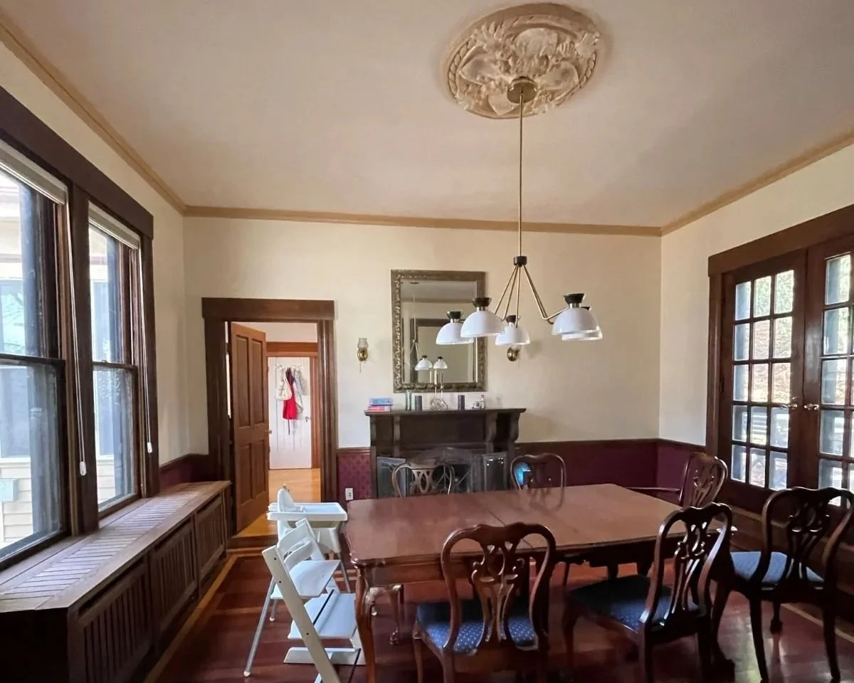 Dining room with original dark stained wood work in 1800s Newton Victorian home