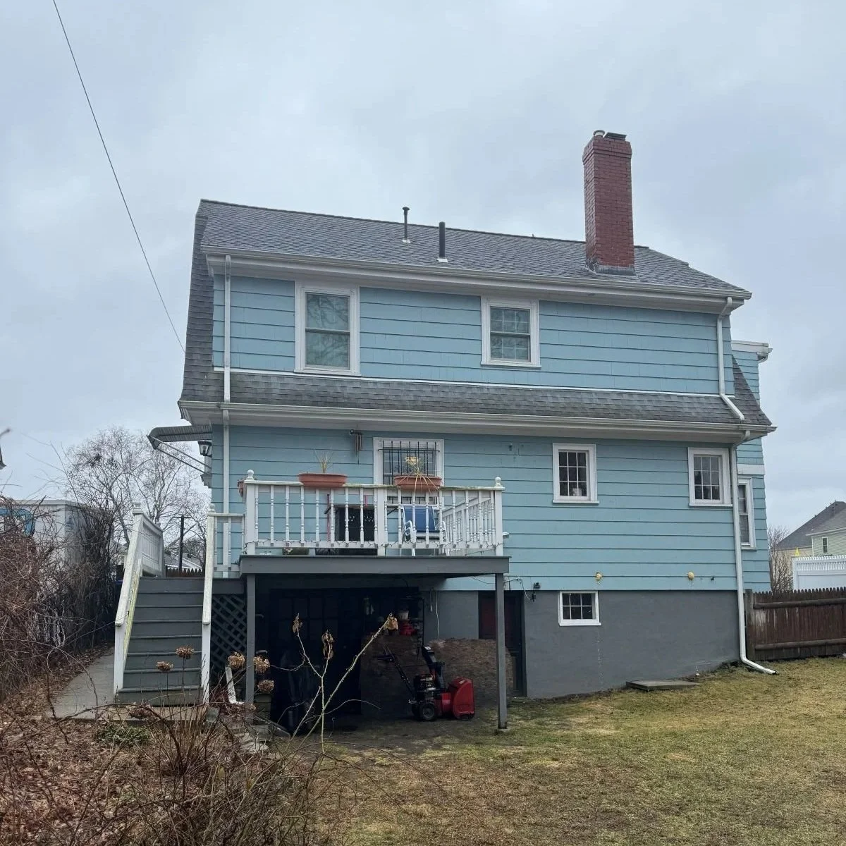 Rear of Dutch colonial home in Medford with deck prior to kitchen addition.